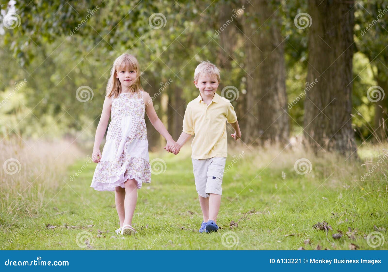 Two Young Children Walking On Path Holding Hands Stock Image Image