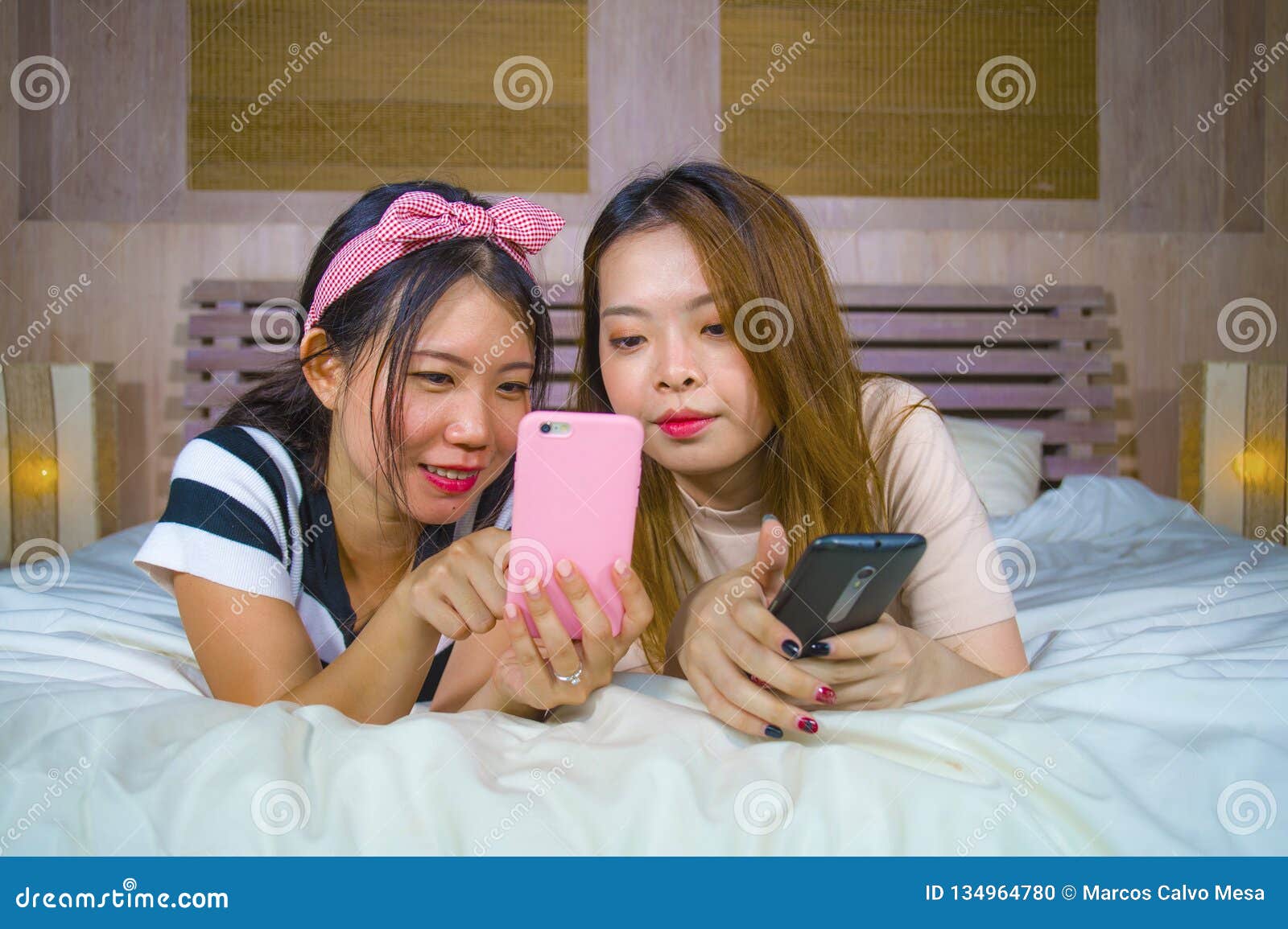 https://thumbs.dreamstime.com/z/two-young-happy-pretty-asian-chinese-girlfriends-sitting-home-bedroom-laughing-talking-having-fun-using-internet-social-134964780.jpg