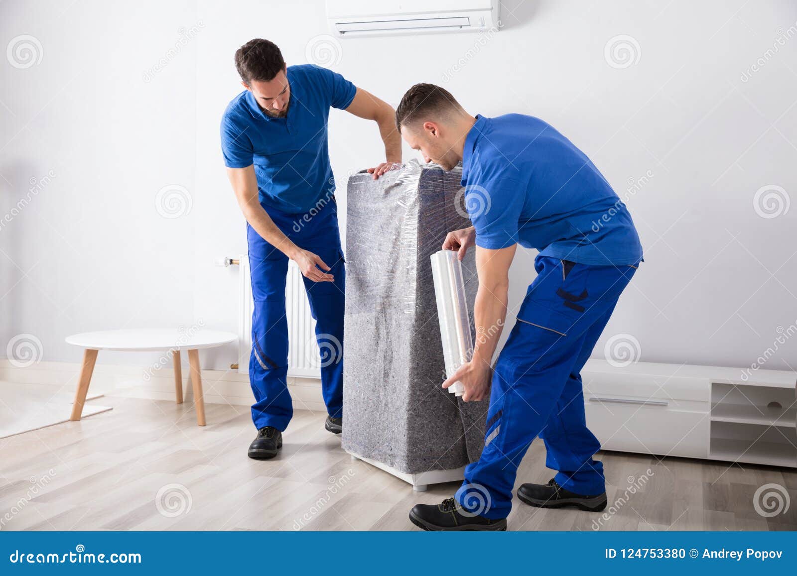 two male movers packing furniture