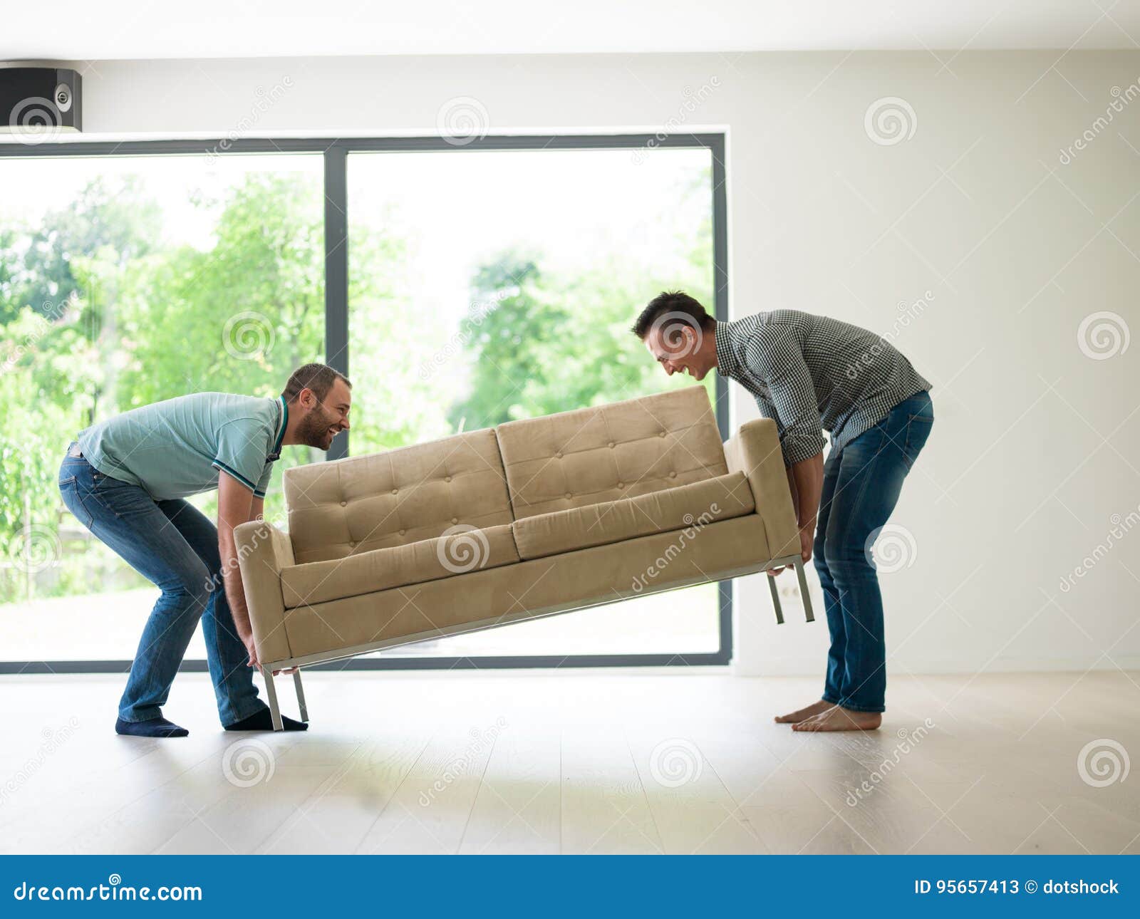 Men carry the sofa stock image. Image of floor, furniture 95657413