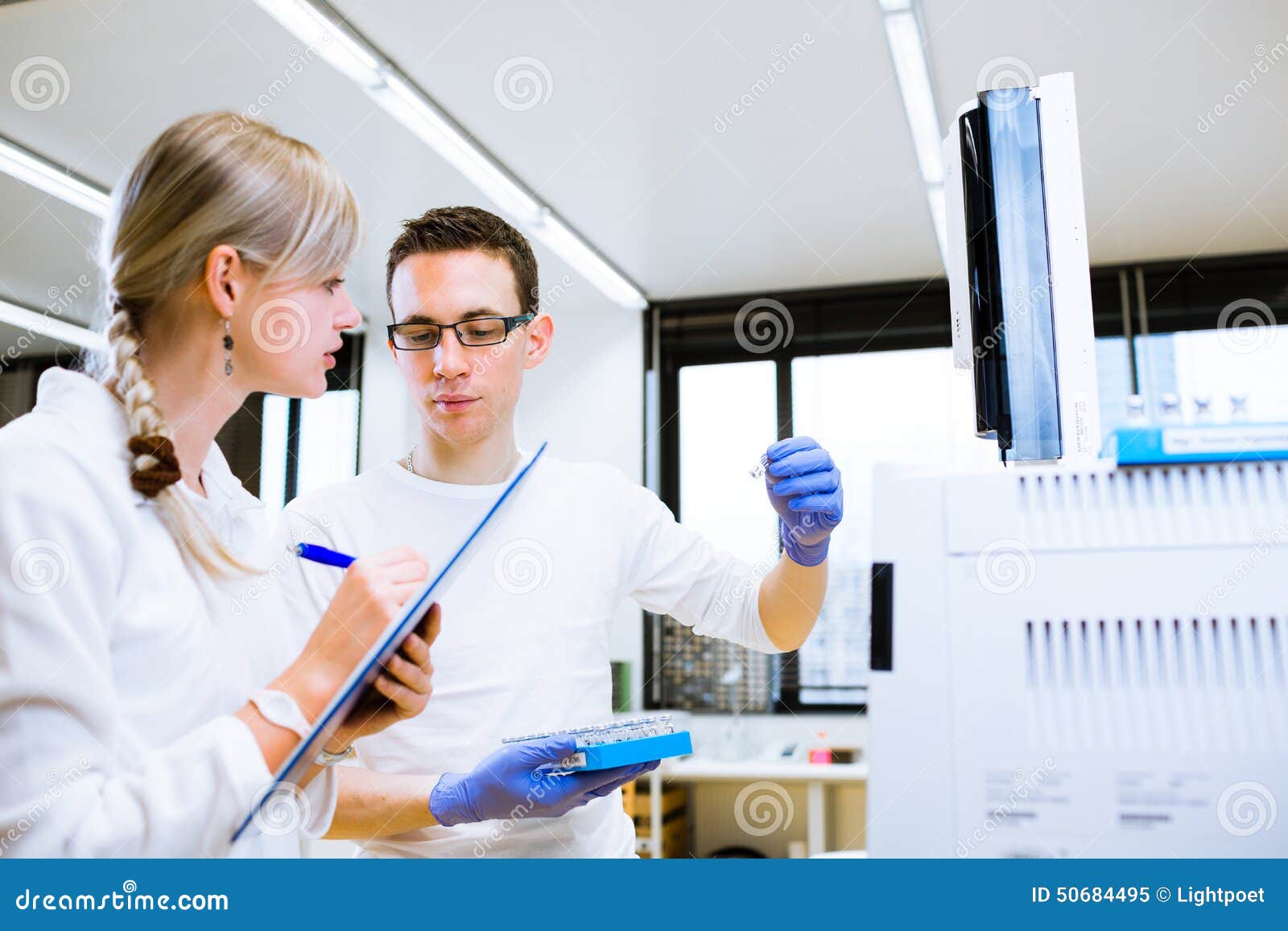 two young researchers carrying out experiments in a lab