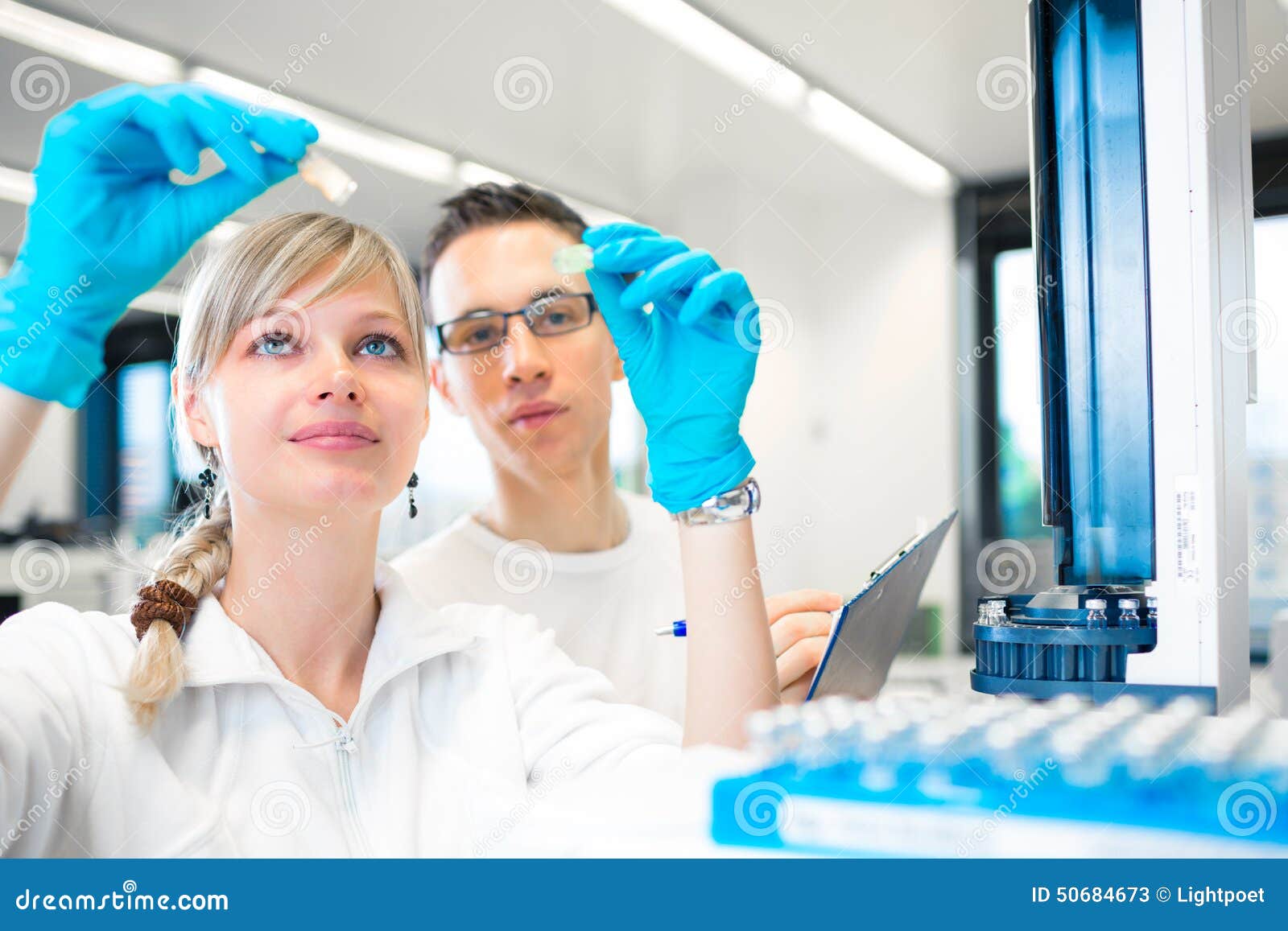 two young researchers carrying out experiments in a lab
