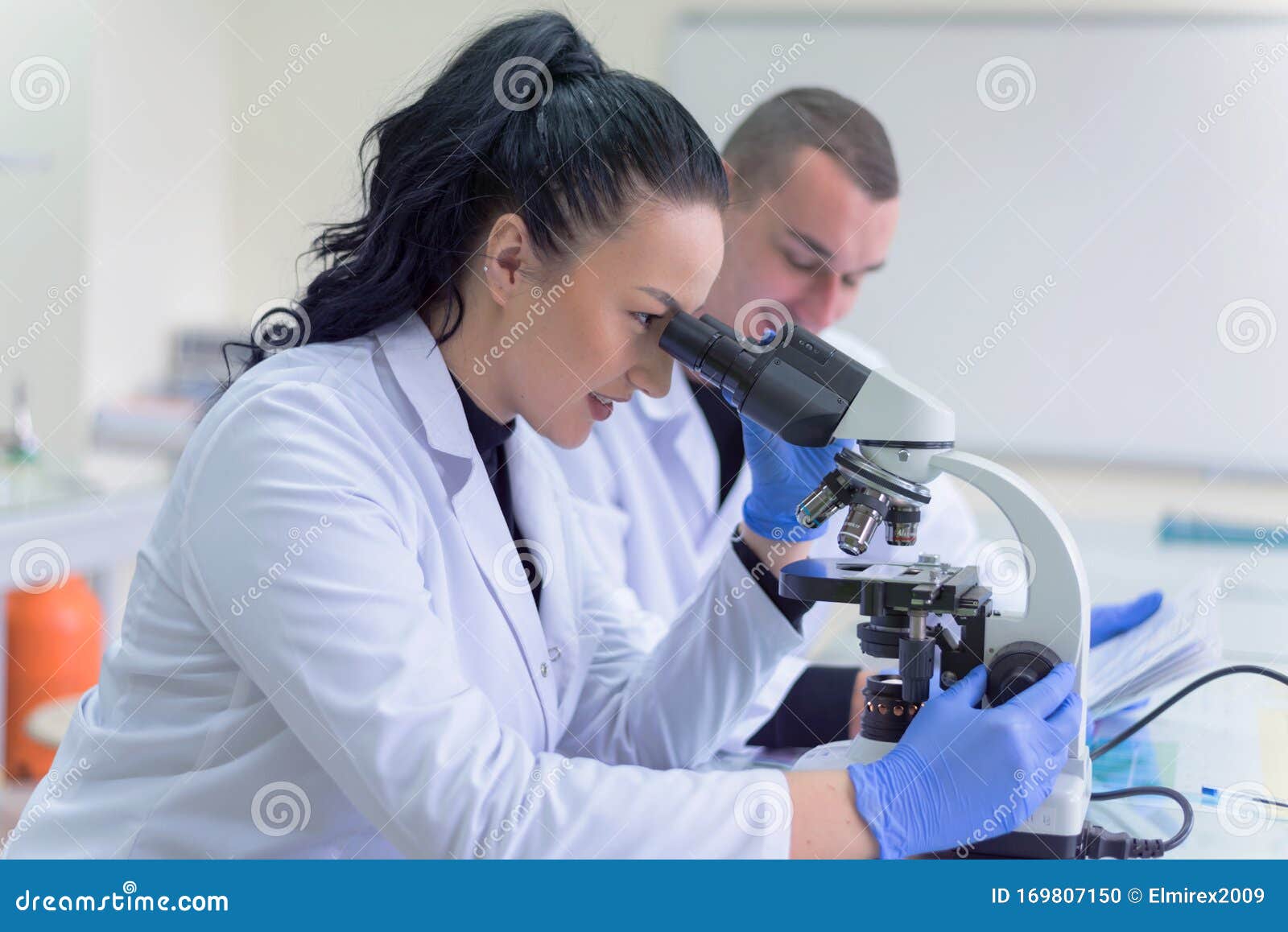 Two Young Scientists Working in a Laboratory and Doing Research