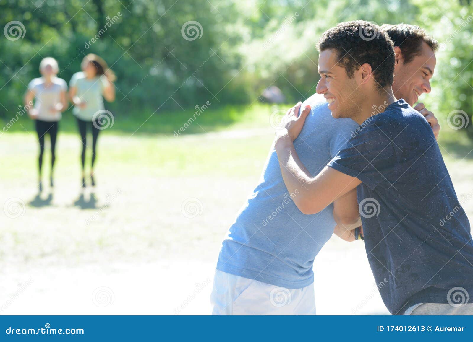 Two Young Sportmen Giving Eachother Hug Stock Image - Image of park ...