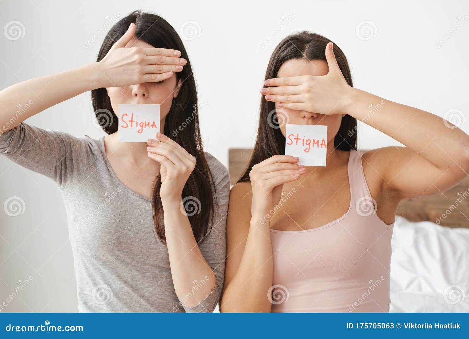 Lesbian Couple In Bedroom At Home Sitting Covering Face
