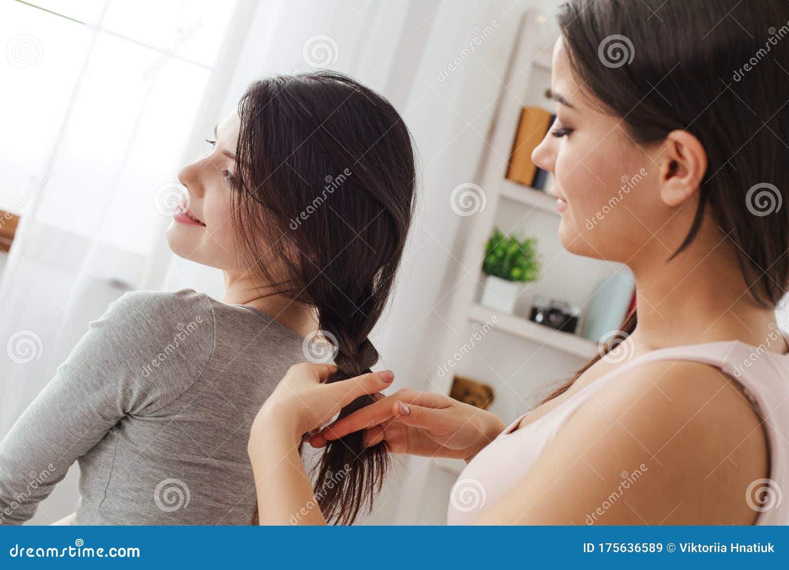 Lesbian Couple In Bedroom At Home Sitting One Woman Making