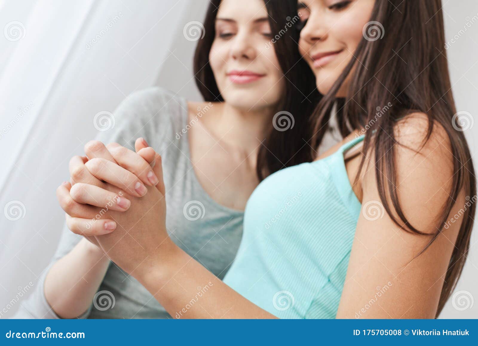 Lesbian Couple In Bedroom At Home Standing Holding Hands