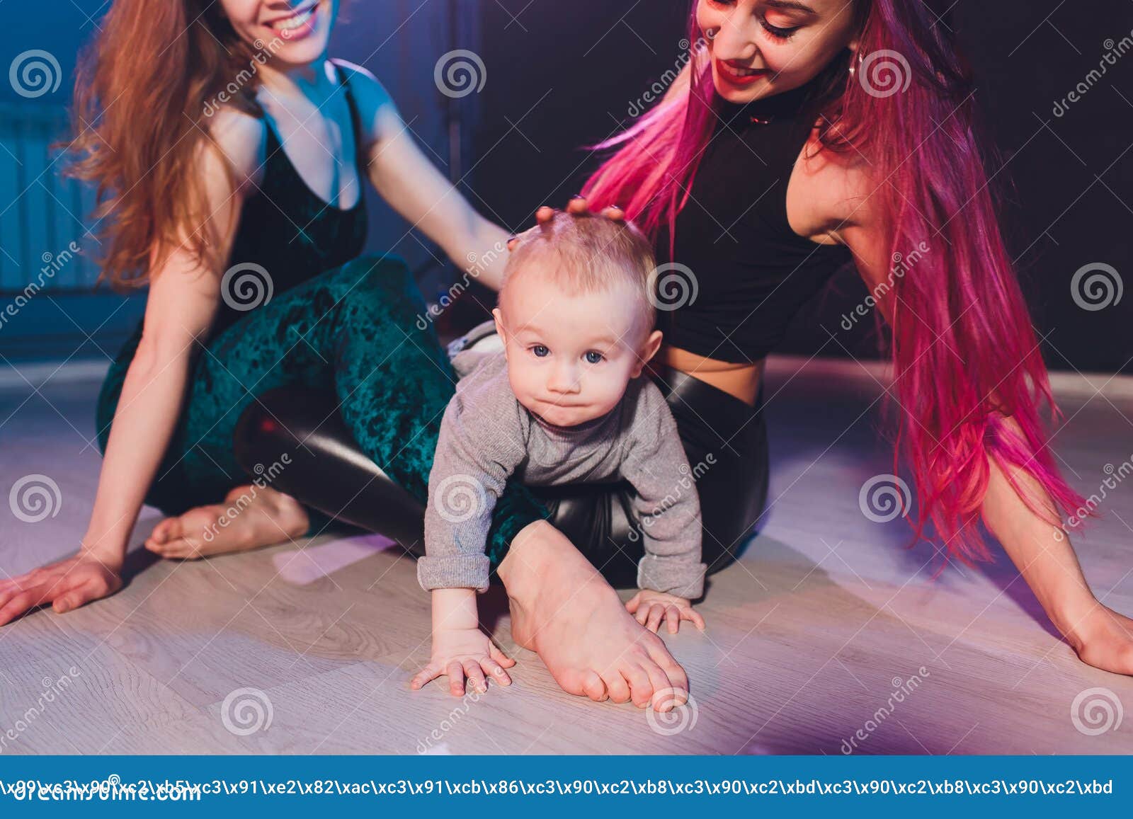 Two Young Women with Dyed Red Hair and in Casual Clothes with a Baby