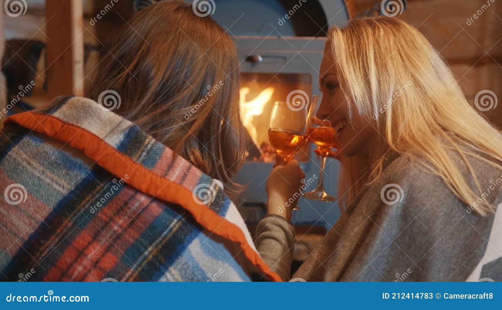 Two Young Women Lesbian Couple Relaxing Near The Fireplace And 
