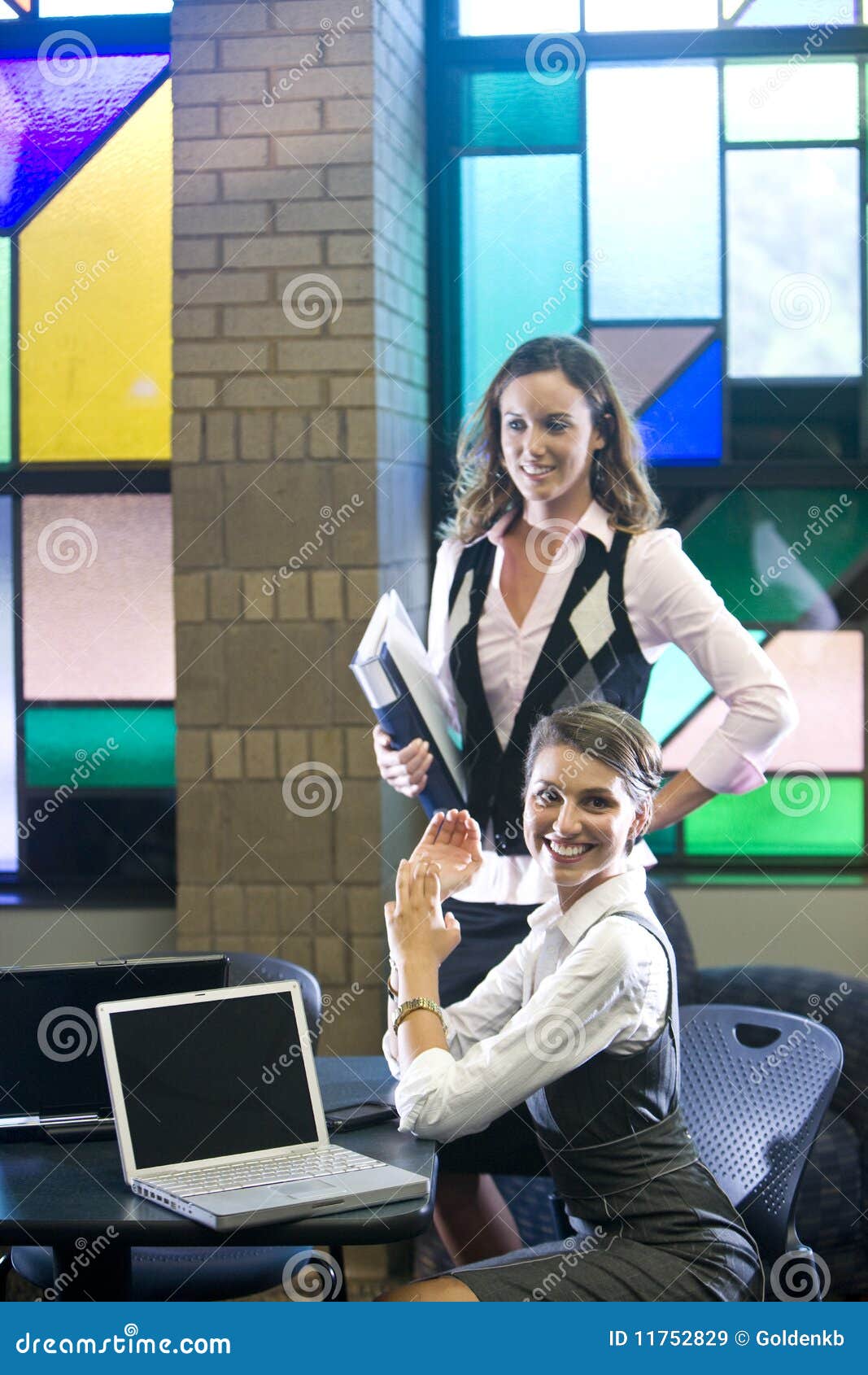 Two Young Women Meeting With Laptops At Table Royalty Free Stock Images - Image: 11752829