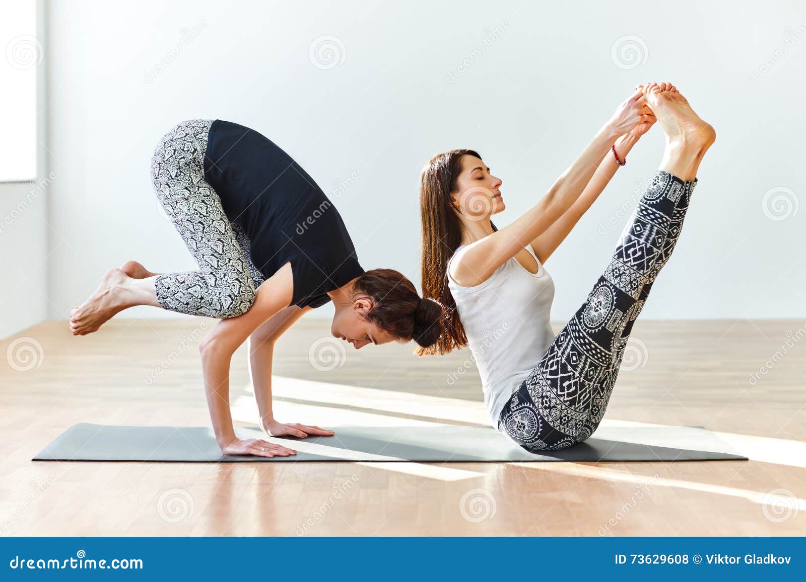 Premium Photo | Young couple practicing acro yoga on mat in studio together  acroyoga couple yoga partner yoga