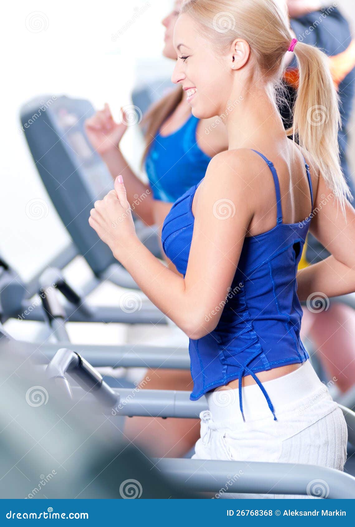 Two Young Women Run on Machine in the Gym Stock Photo Image of coach, female 26768368