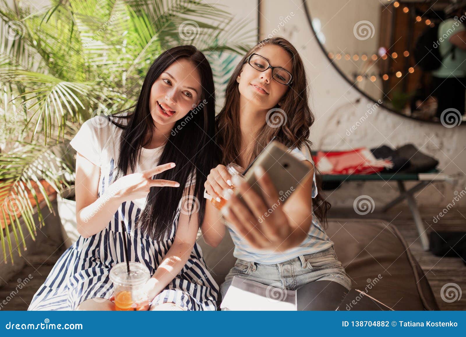 Two Youthful Smiling Beautiful Slim Girls with Long Dark Hair,wearing ...