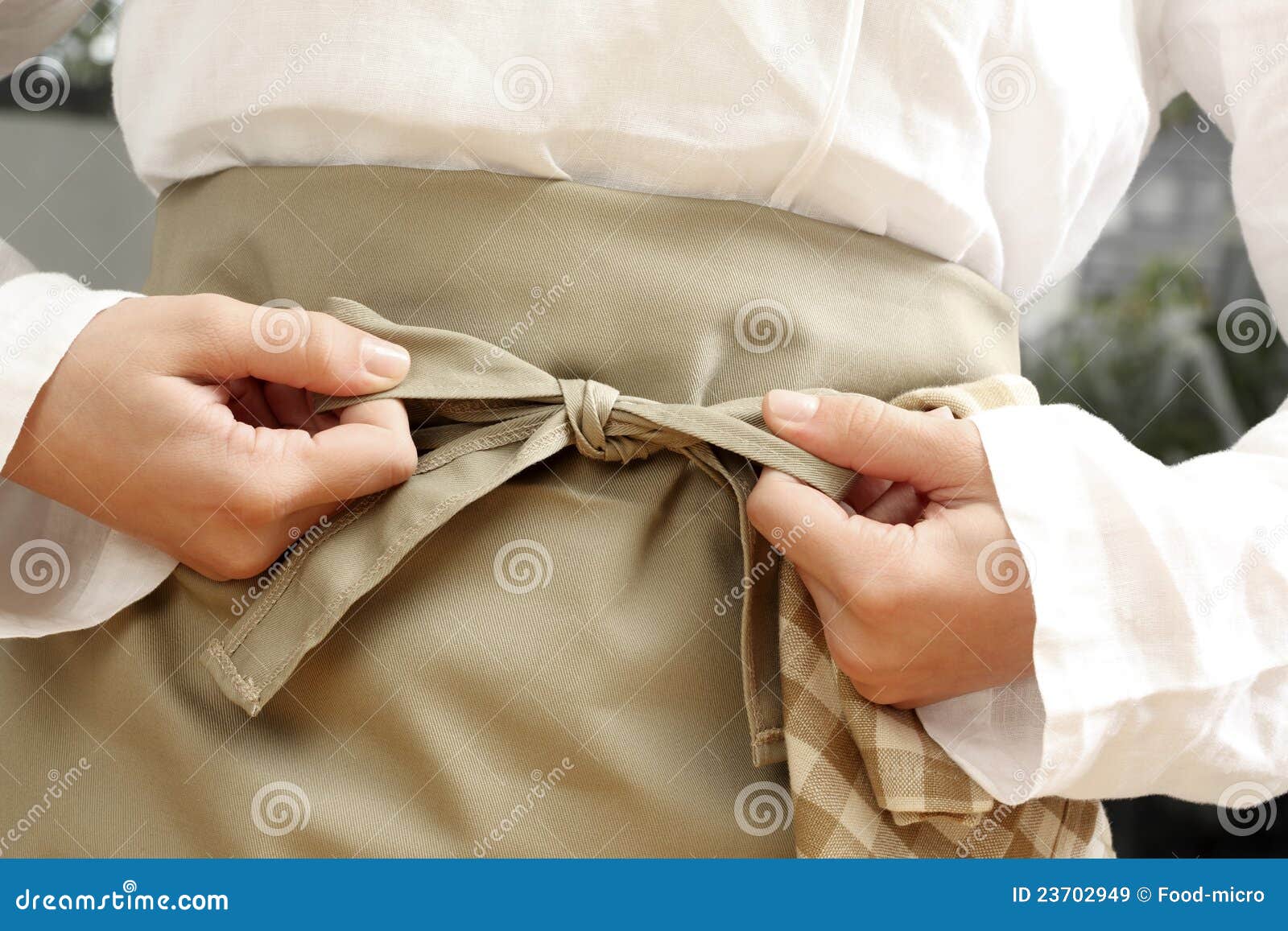 tying an apron around the waist