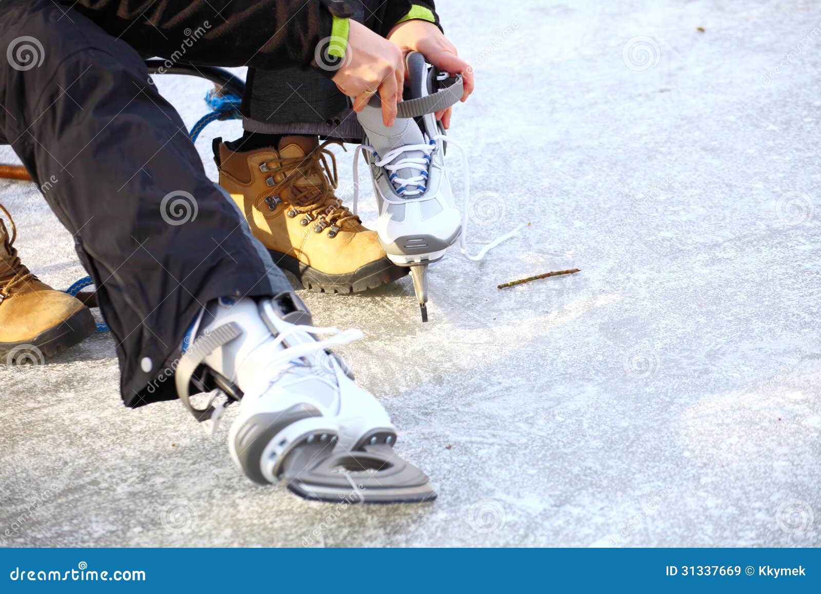 tying laces of ice hockey skates skating rink