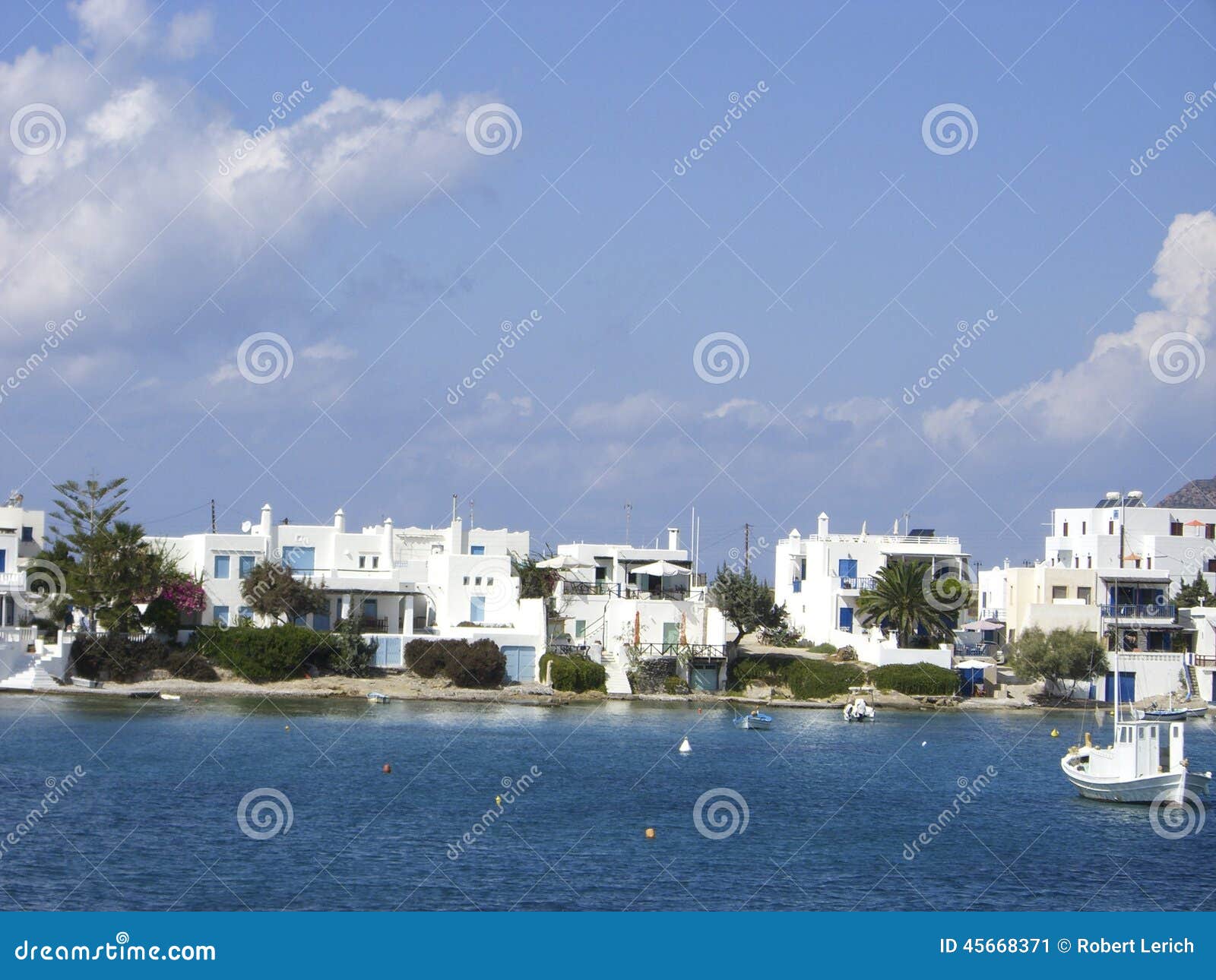 typical beach community with cyclades style white house blue door pollonia milos greece