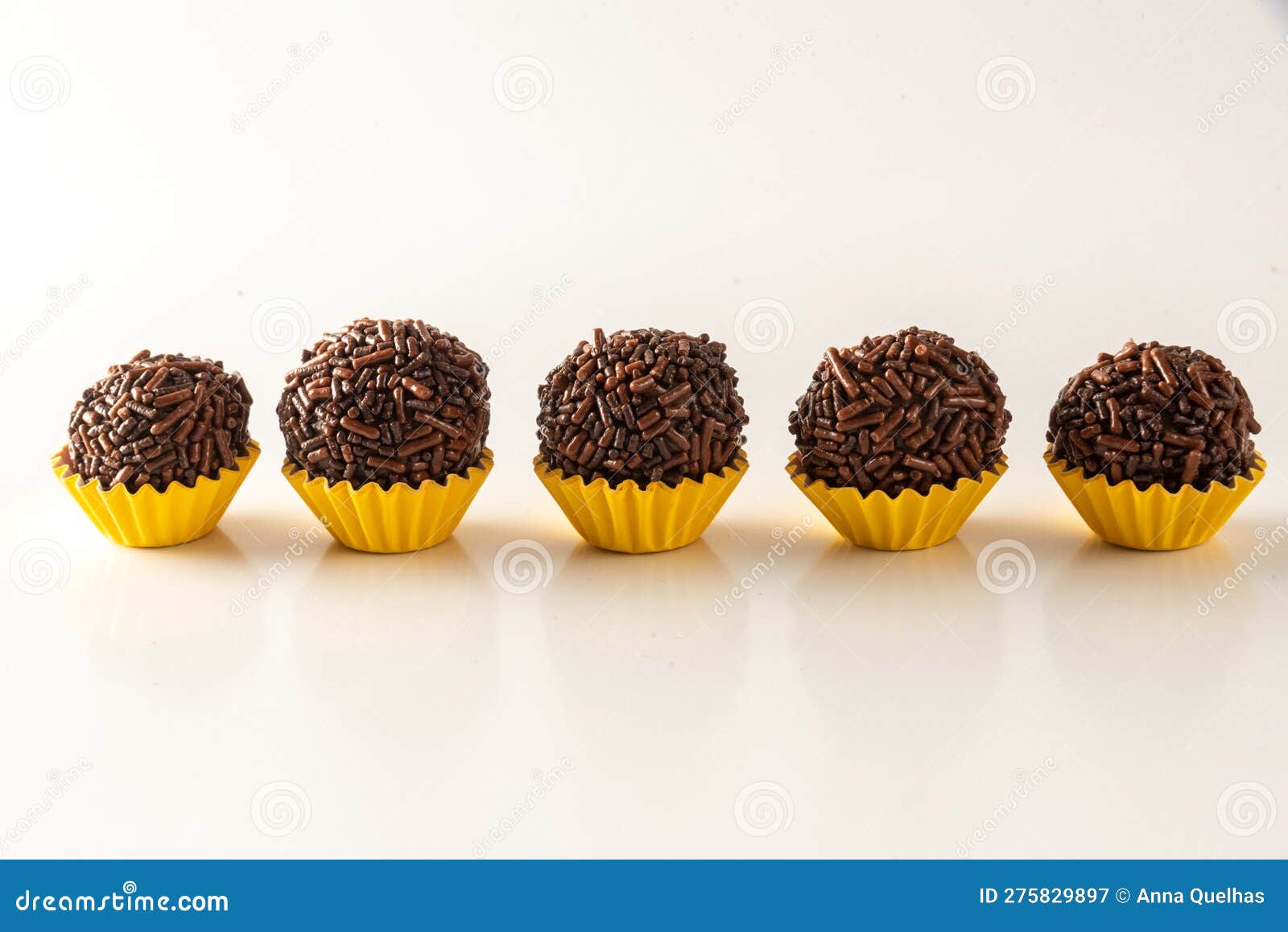 typical brazilian brigadeiros,  on white background and yellow mold