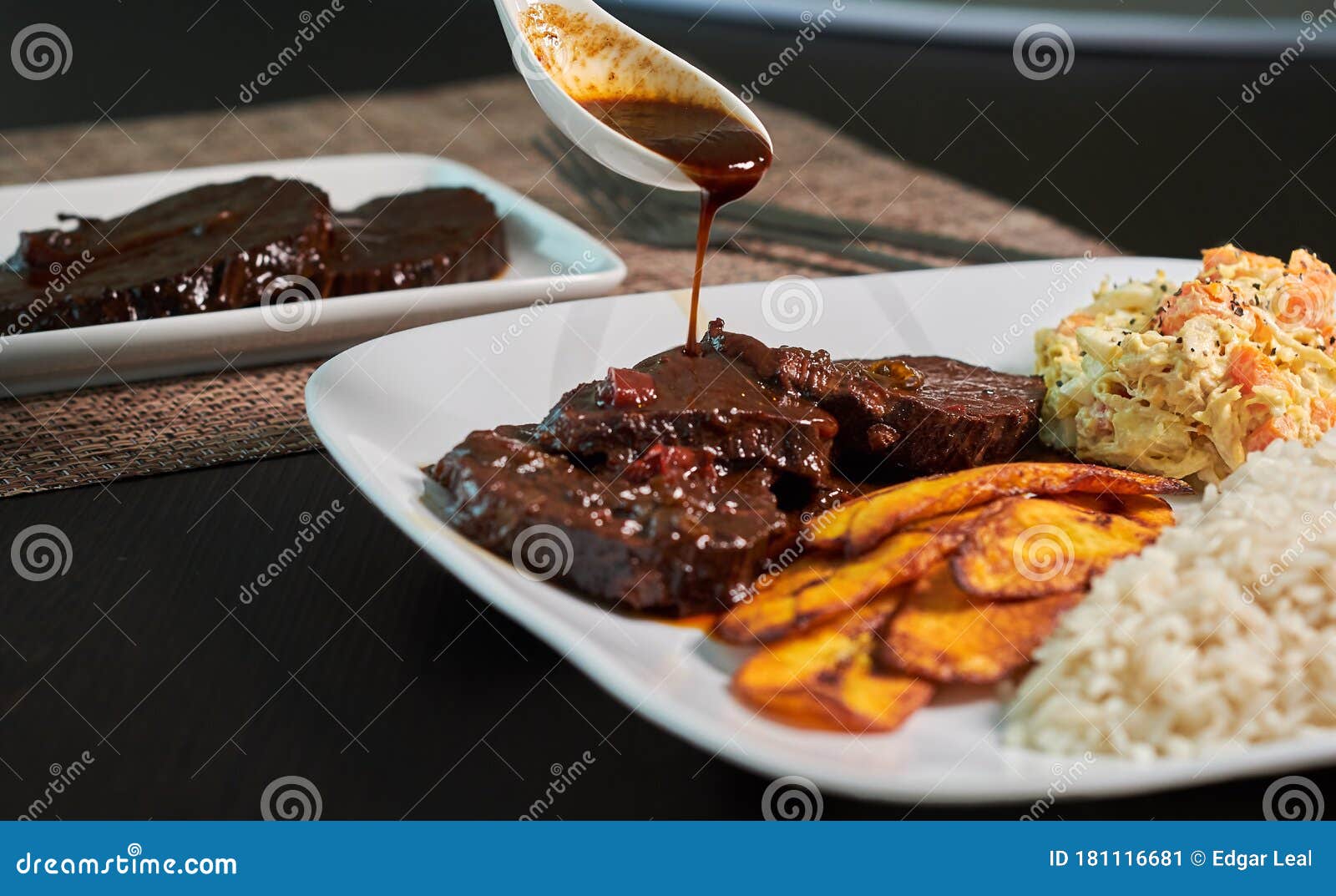 typical dish of black roasted venezuela with chicken salad and banana