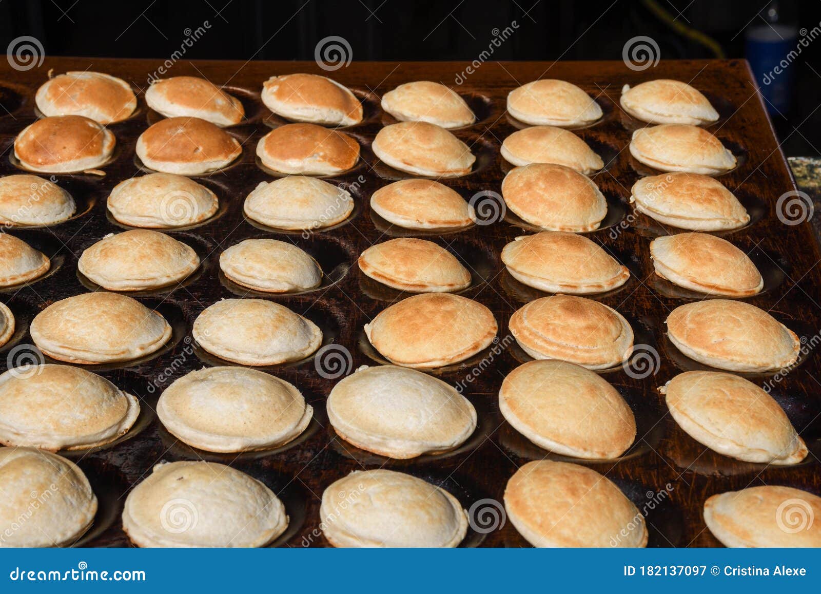 Homemade Dutch Poffertjes In A Traditional Cast Iron Pan Isolated On White  Background Stock Photo, Picture and Royalty Free Image. Image 66312095.