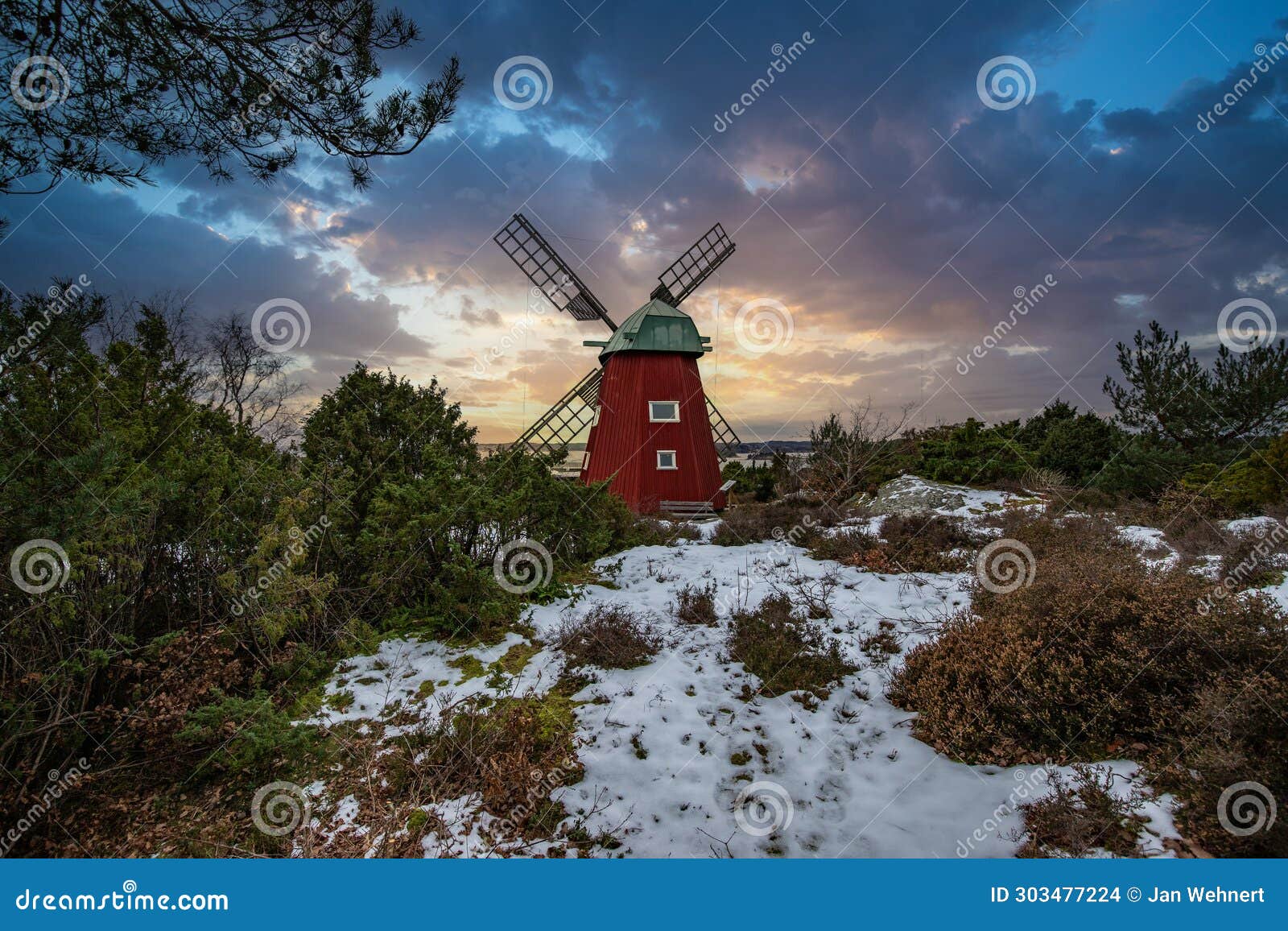 historical windmill made of red wood in a winter landscape.stenungsund in sweden