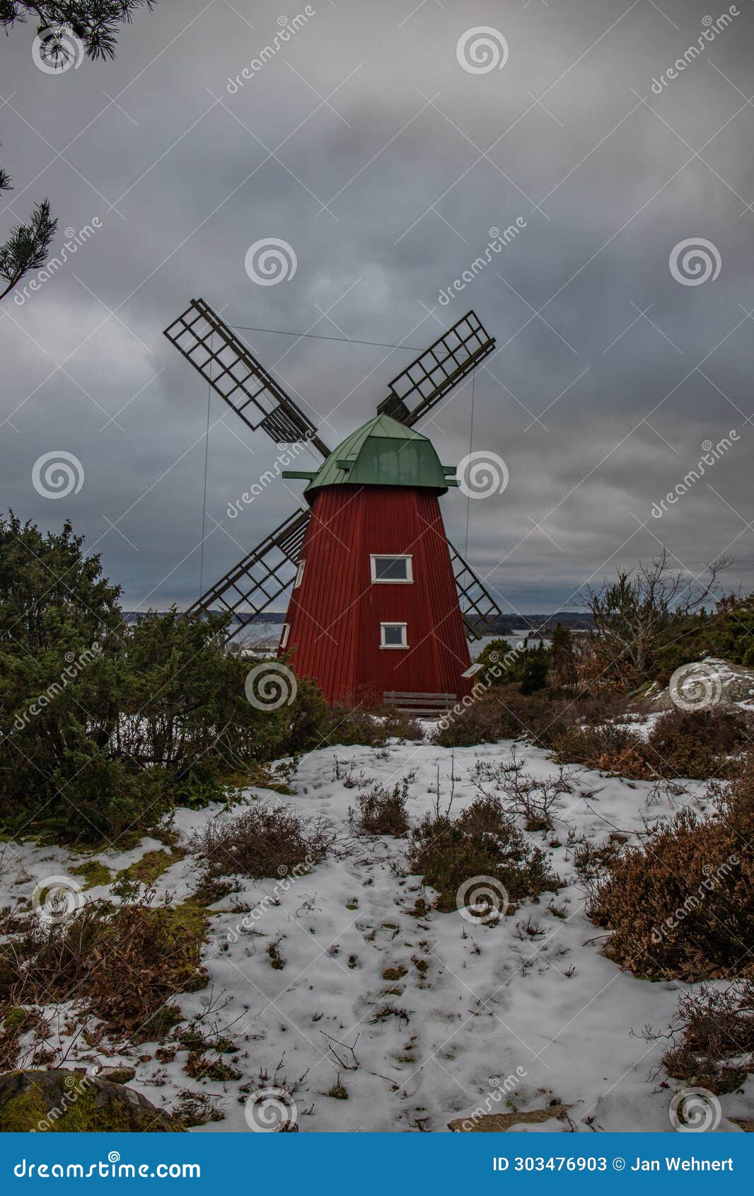 historical windmill made of red wood in a winter landscape.stenungsund in sweden