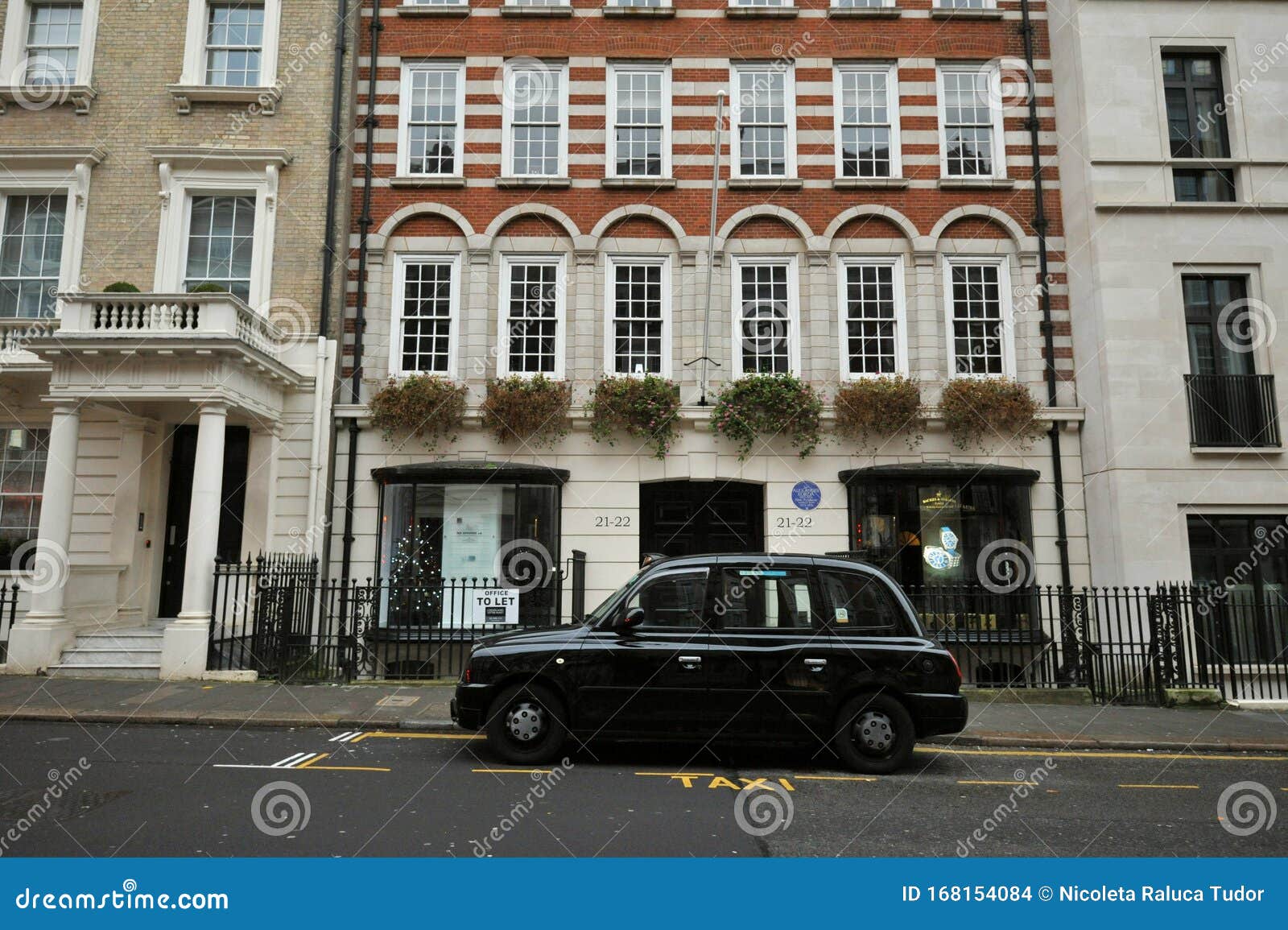 Typical House in Mayfair London with a Typical Black Cab Editorial