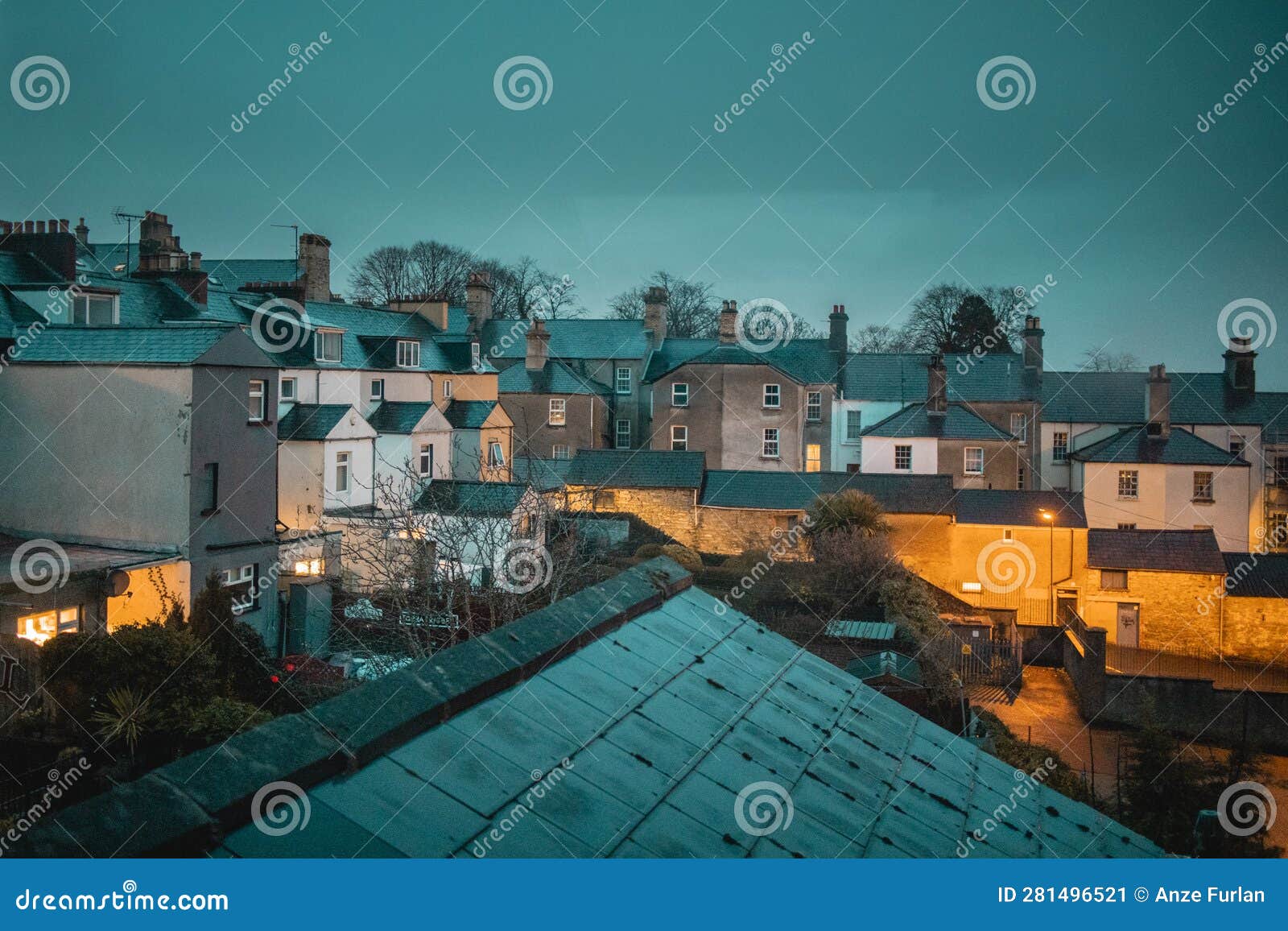 typical houses at night  in a derry suburb viewed from a high window or roof terrace. nice white houses in line above the city of