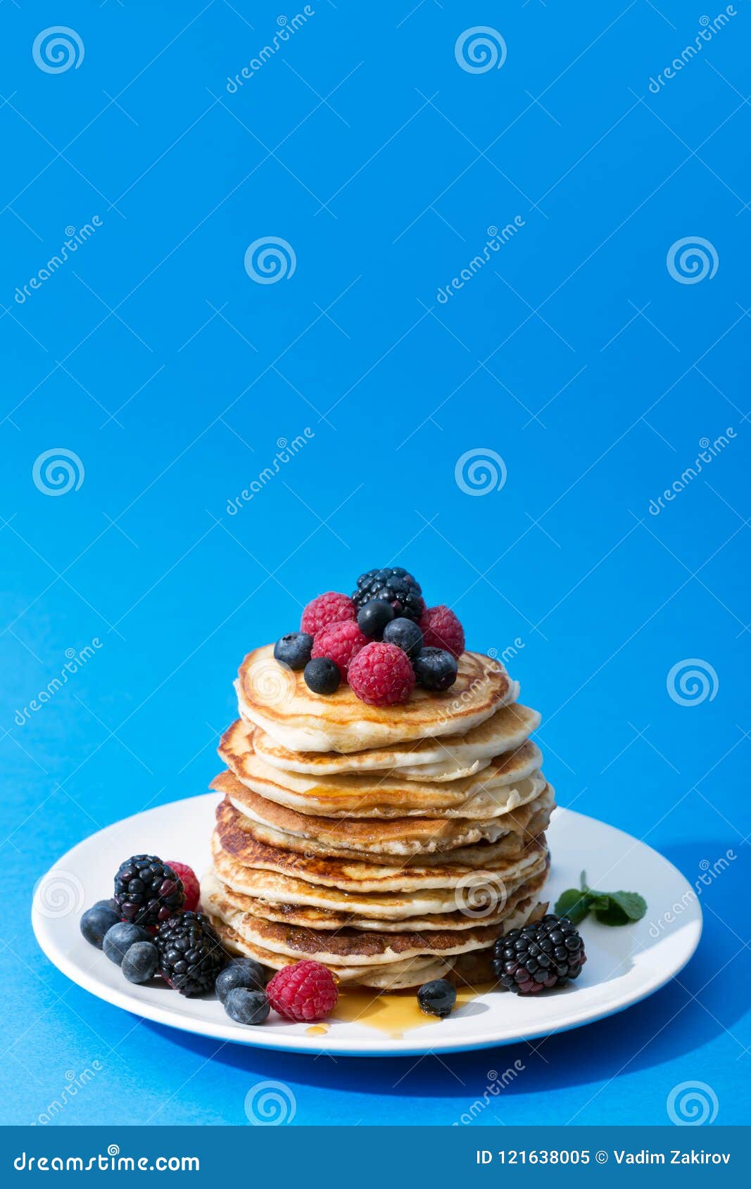 pancakes with berries on the pale and honey