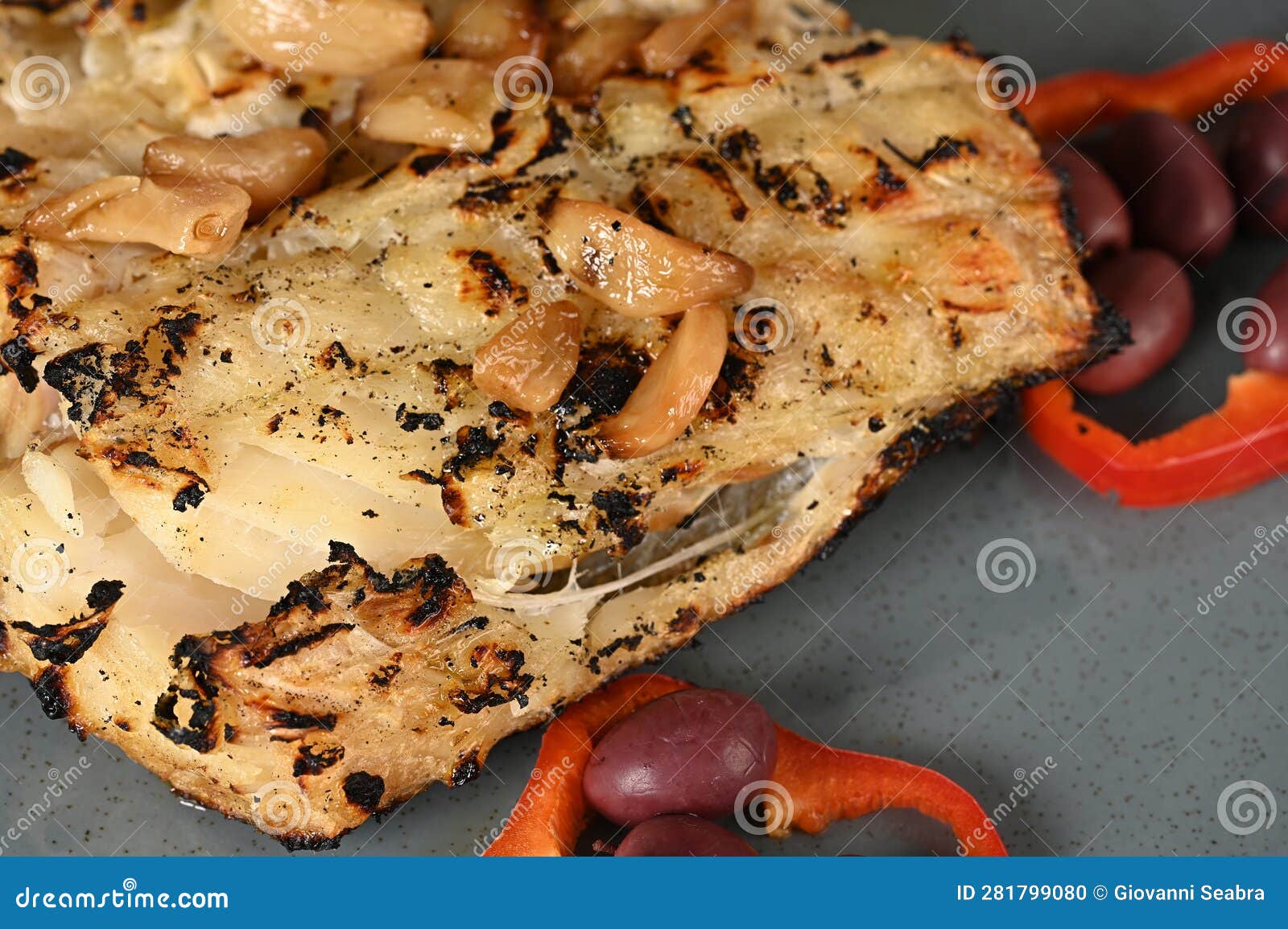 typical portuguese dish roasted codfish with onion garlic peppers and rustic babata lusitanian food