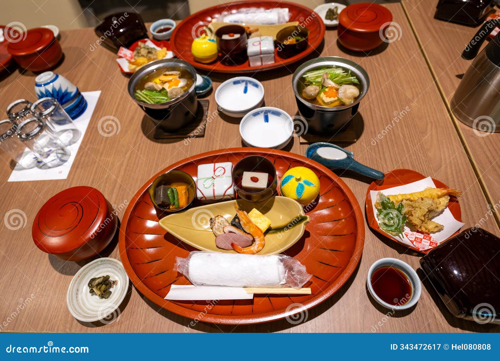 typical starter in japan with soup, raw fish, prawns, tofu, seaweed and vegetables,.beautiful arranged