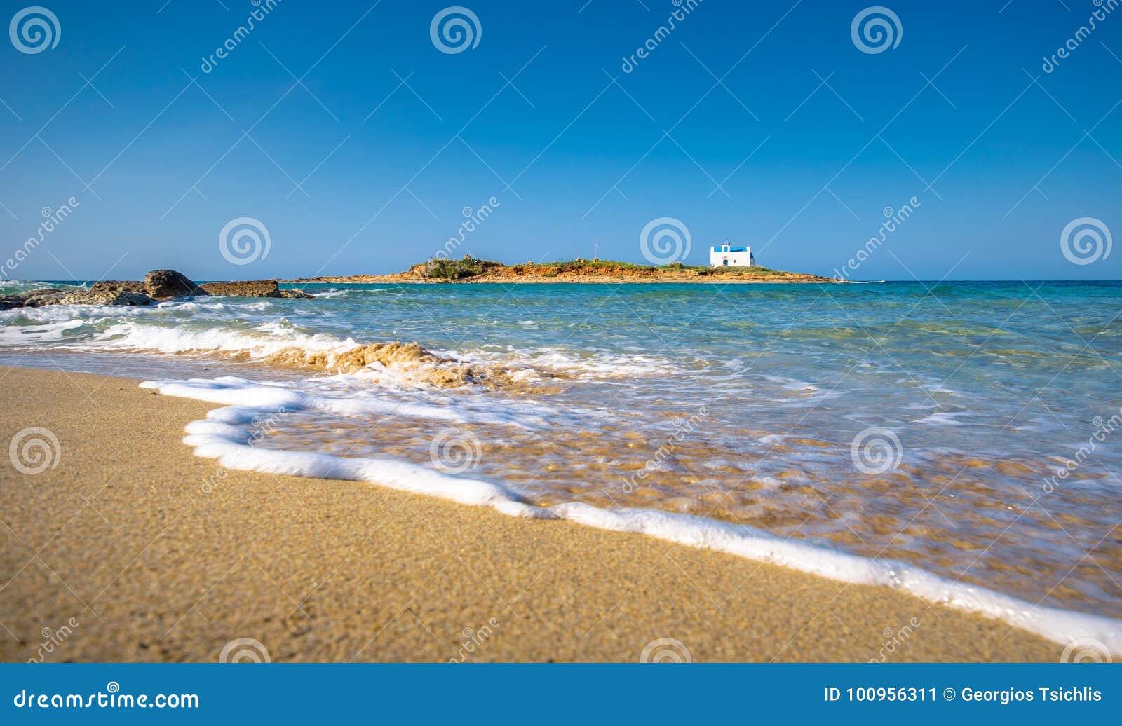 typical summer image of an amazing pictorial view of a sandy beach and an old white church in a small isl