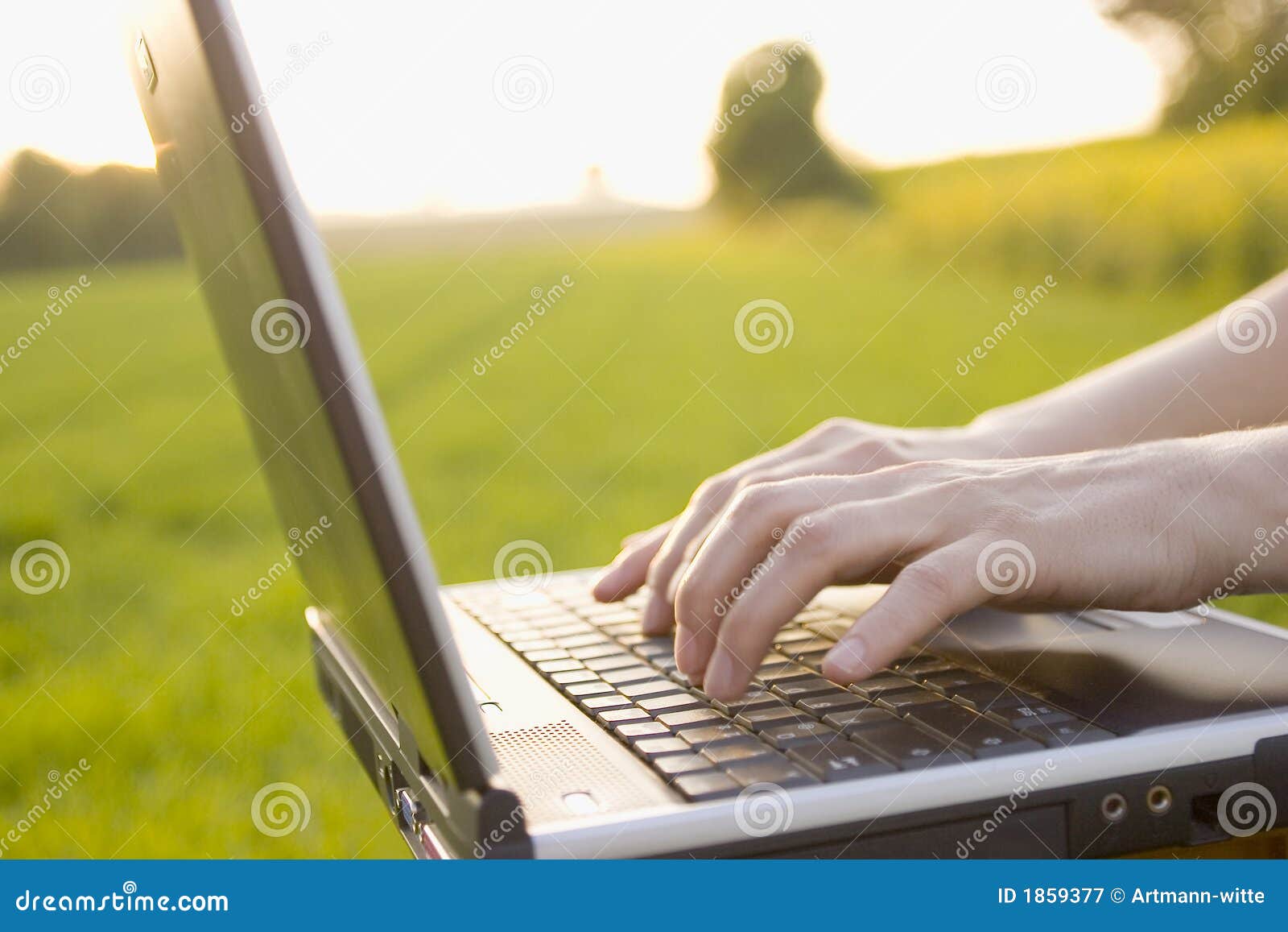 typing on a laptop outside