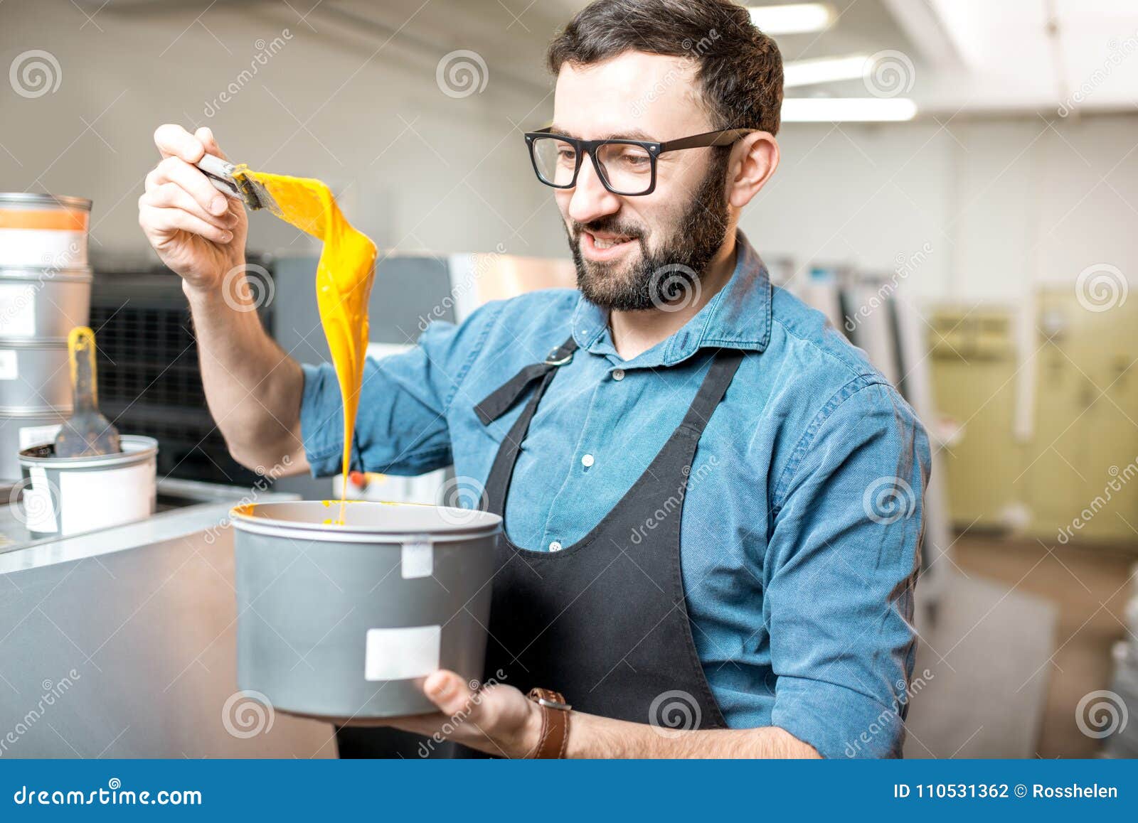 typographer with paint at the manufacturing
