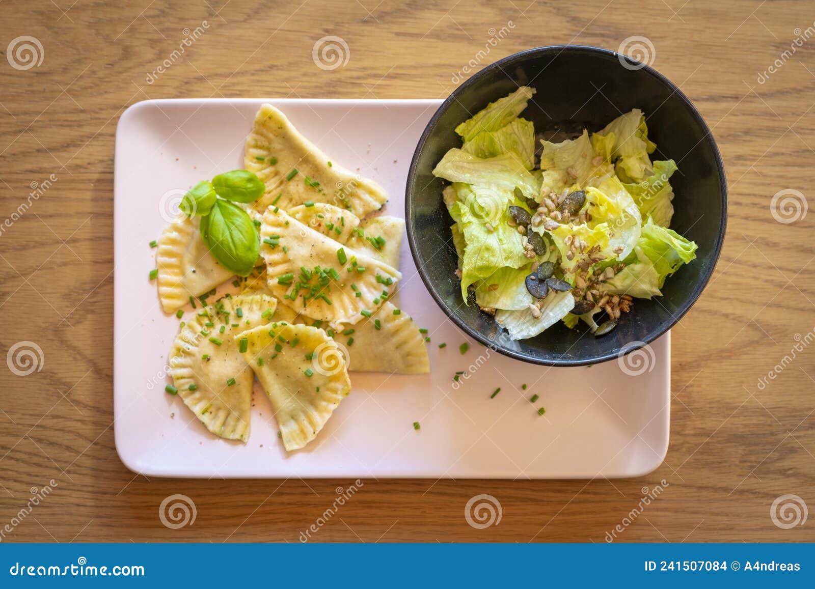 tyrolean dumplings filled with spinach served with chives, basil leaves