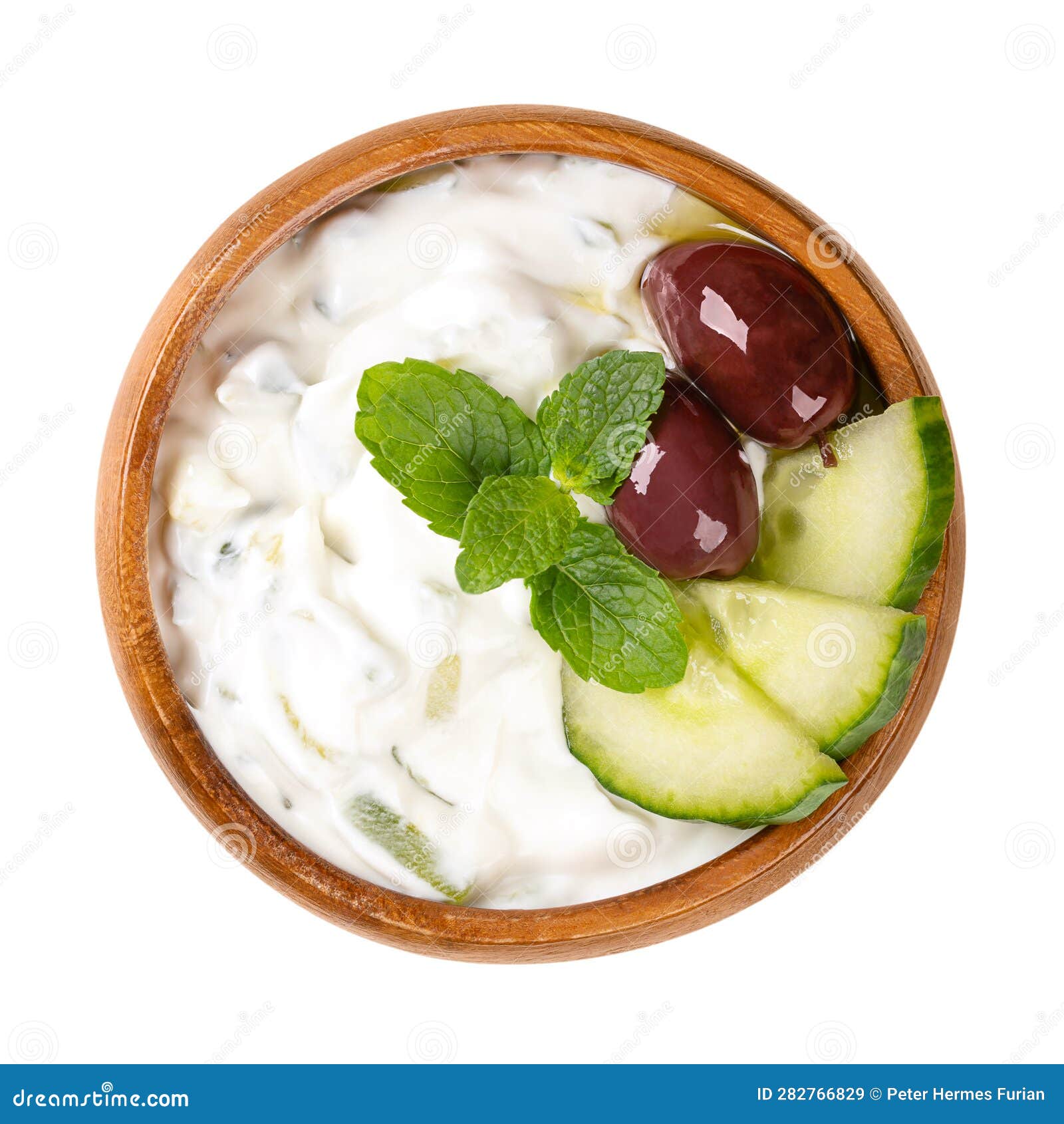 Tzatziki, Greek Yogurt Dip Sauce, with Olives and Mint Leaves in Wooden