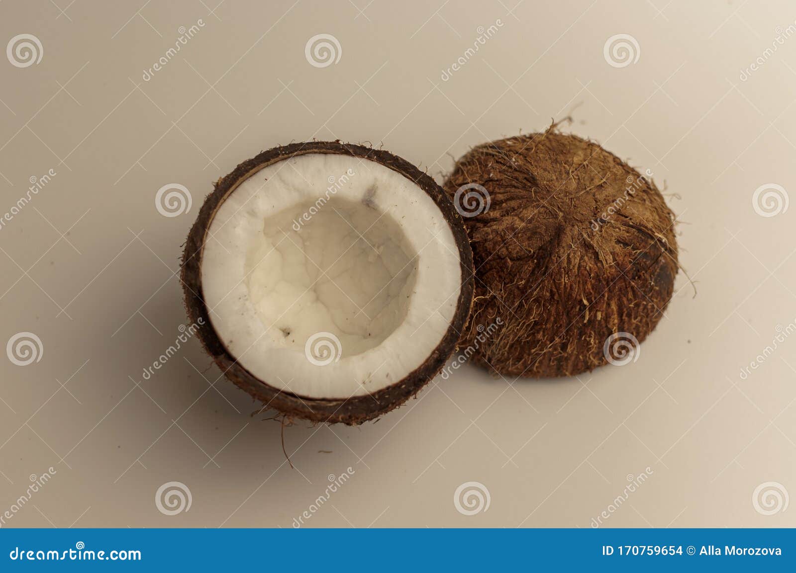 Ugly Organic Coconut on a White Background, Isolate. a Broken Nut in a