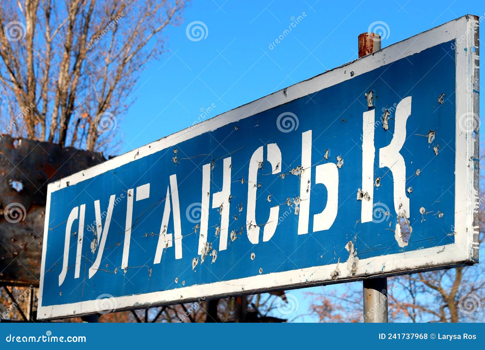 ukraine russia war road sign in ukrainian - lugansk, pierced by bullets, ukrainian war in donbass destruction, ukraine border, ato