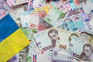 Ukrainian Hryvnia Banknotes On The National Flag Of Ukraine Stock Ukrainian Hryvnia Banknotes On The National Flag Of Ukraine Stock