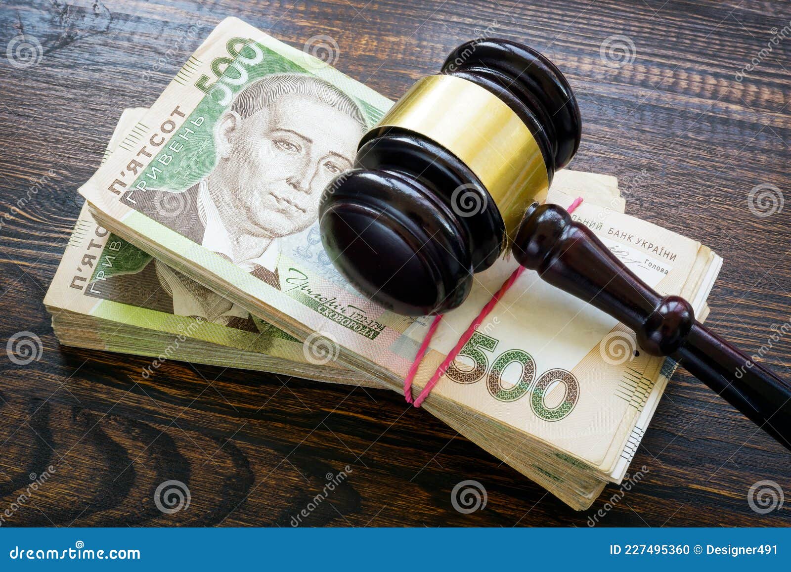 ukrainian hryvnia money and a gavel. bribery and corruption in court.