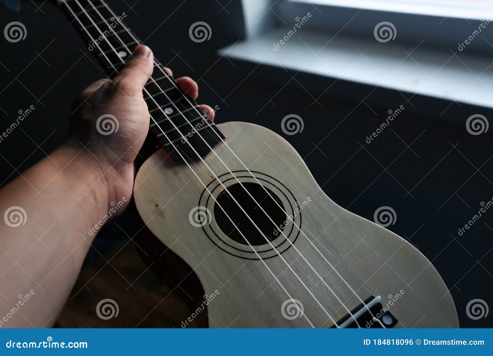 Ukulele in hand stock photo. Image of guitar, blue, neon 184818096