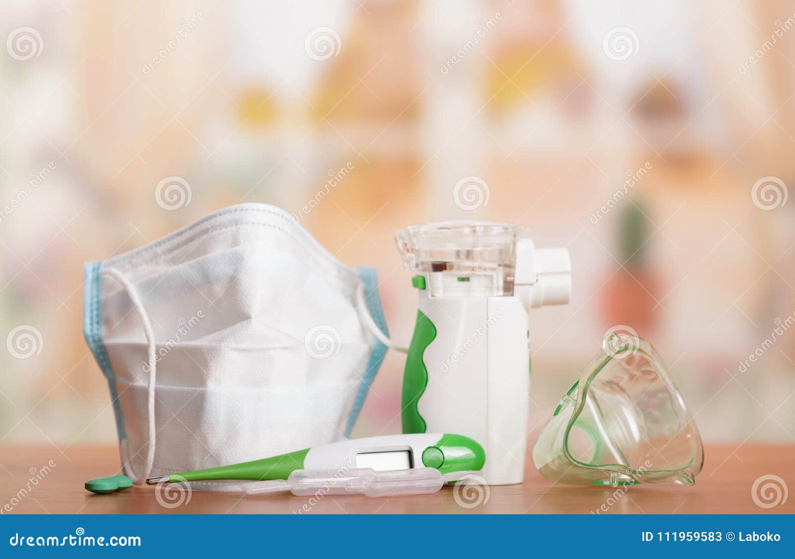 ultrasonic mesh nebulizer, gauze mask, pills and thermometer on light