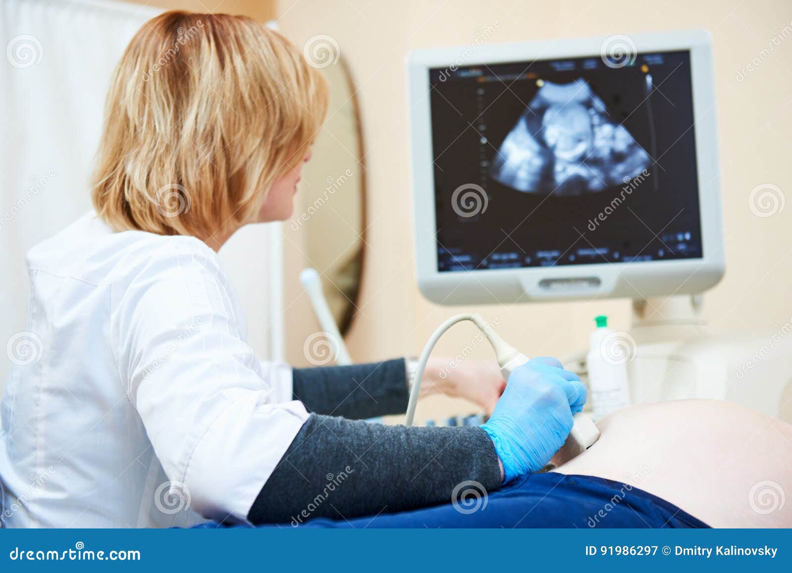 ultrasound test. pregnancy. gynecologist checking fetal life with scanner.