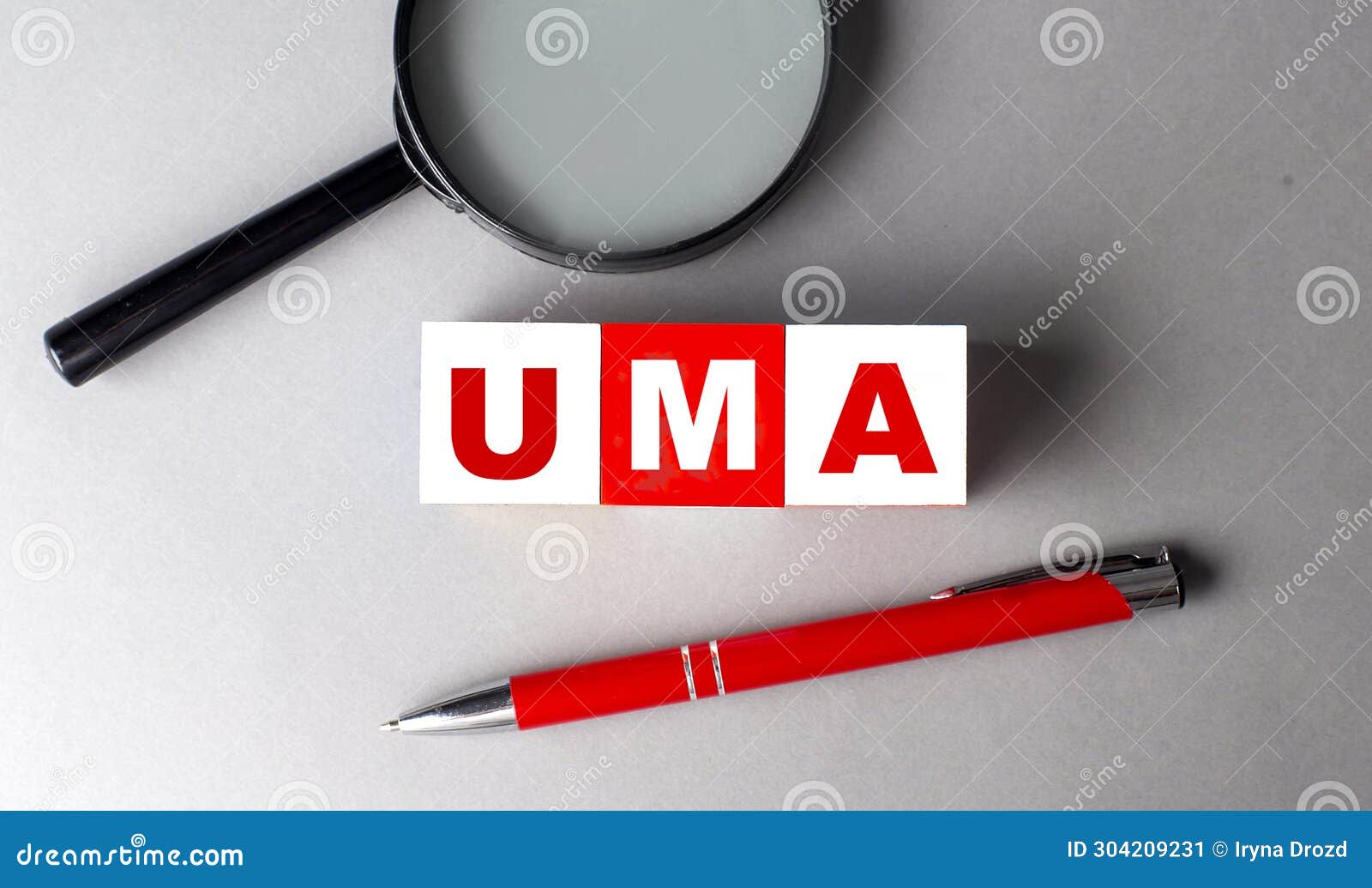 uma word on wooden cubes with pen and magnifier