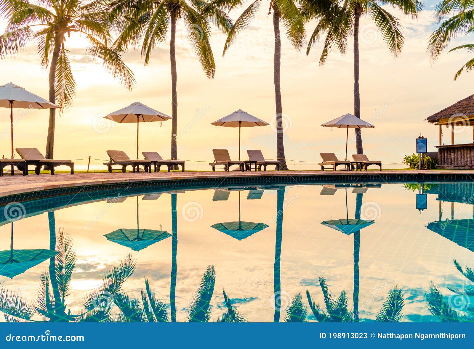 umbrella and chair around swimming pool in resort hotel for leisure travel and vacation neary sea ocean beach