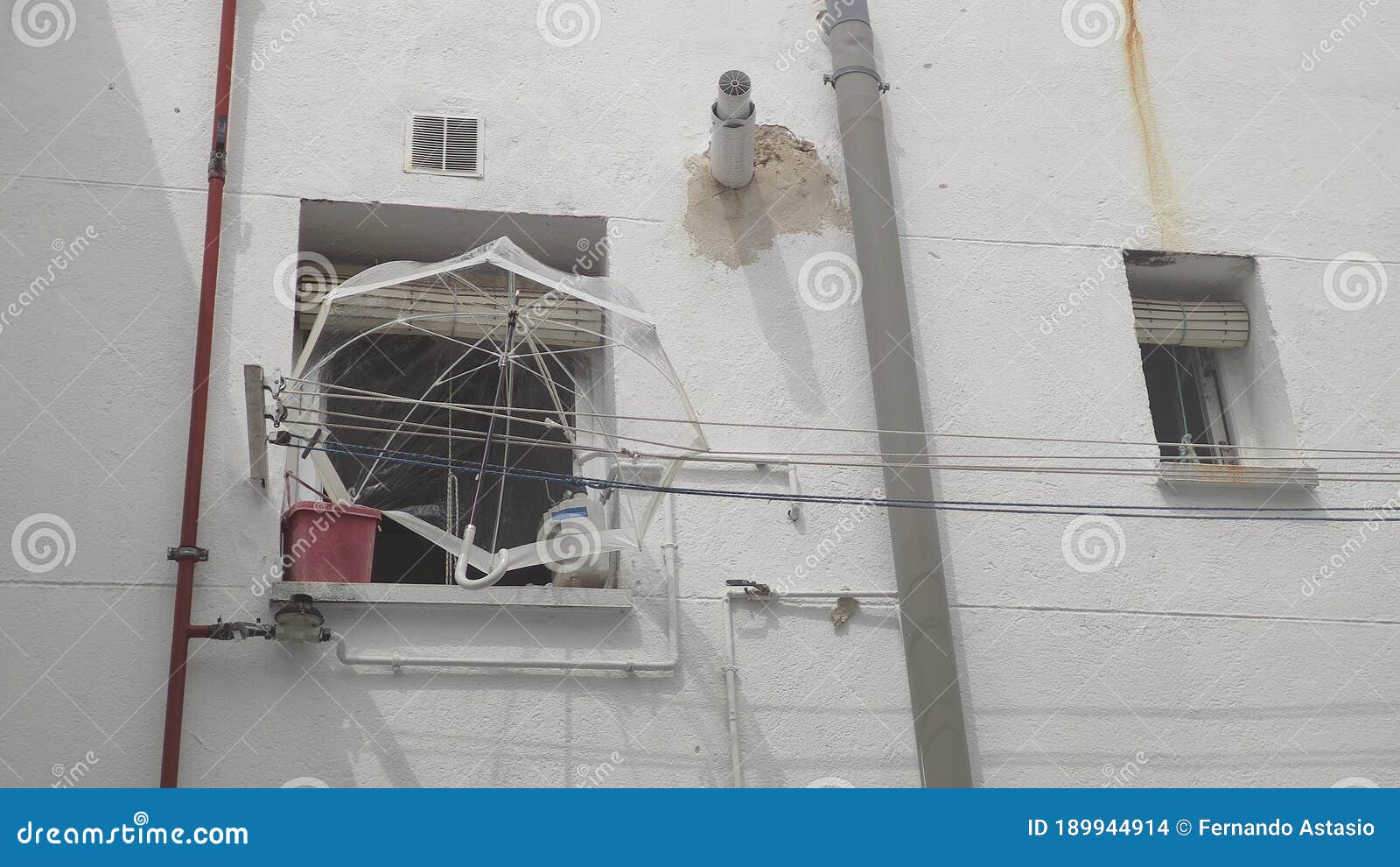 umbrella resting on the clothes lines in the courtyard