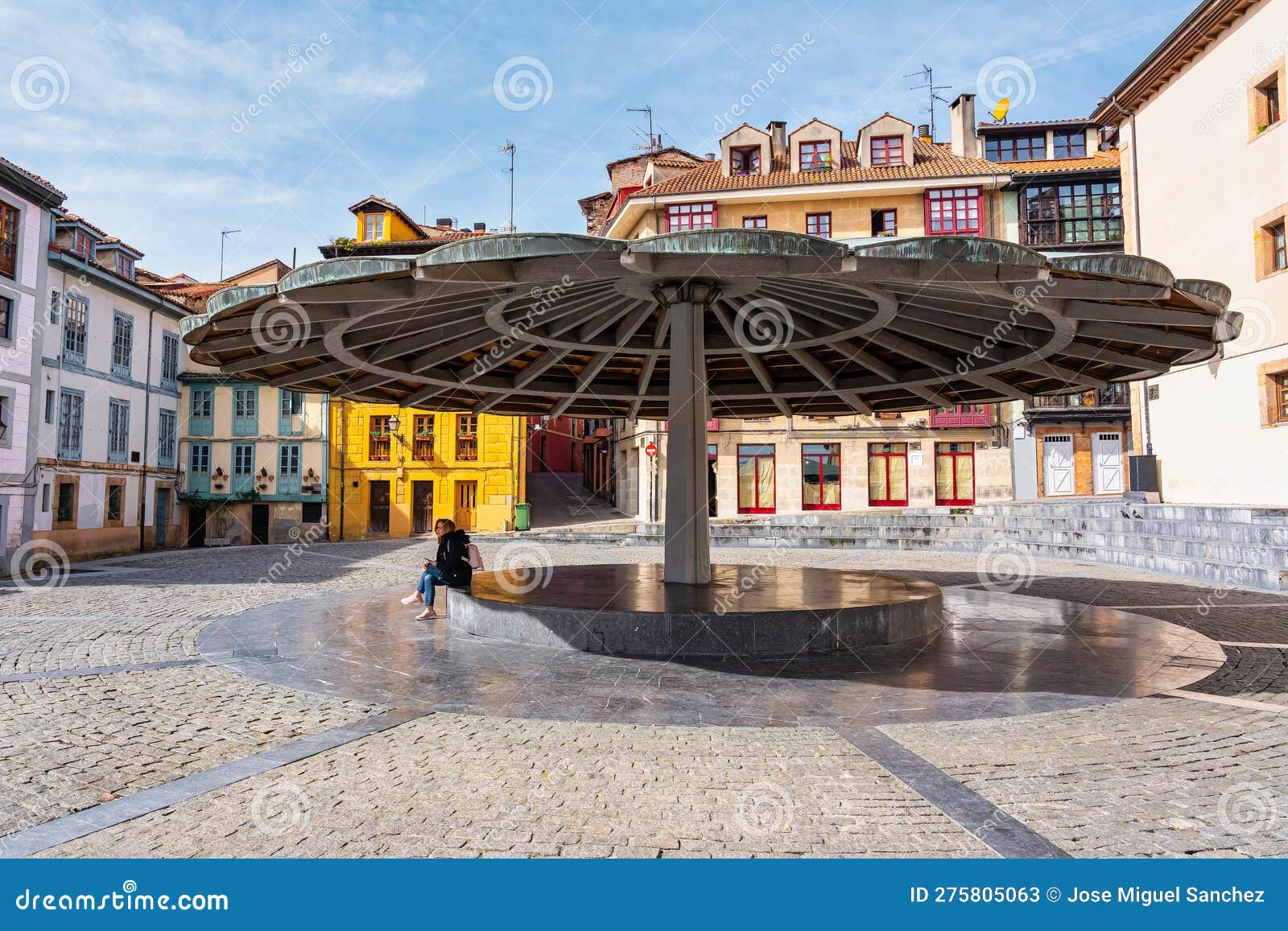 the umbrella square with picturesque buildings of striking colors in the surroundings of the square, oviedo, asturias.