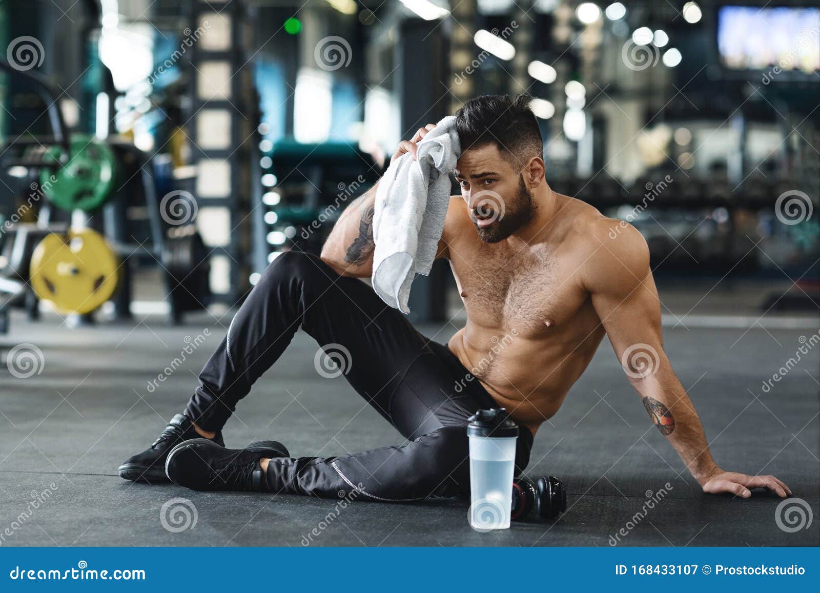 Hombre guapo deporte fuerte descansando después de hacer ejercicio
