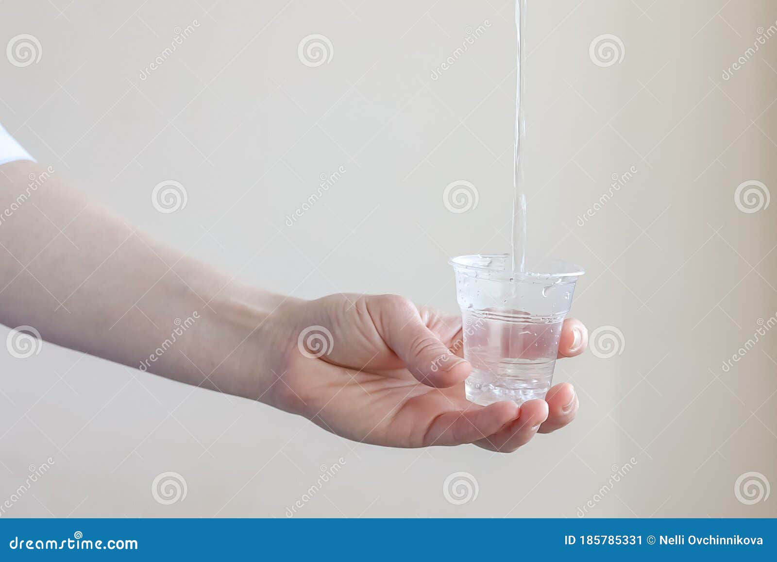 Un Filet D'eau Verse Dans Un Gobelet En Plastique Transparent Image stock -  Image du intérieur, beige: 185785331