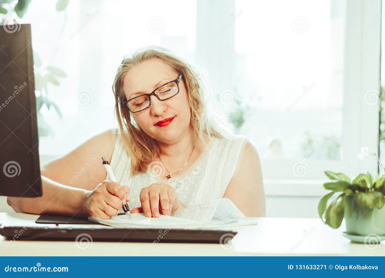 Una donna anziana scrive con una penna. Donna anziana senior che annota le lettere su pezzo di carta, recor