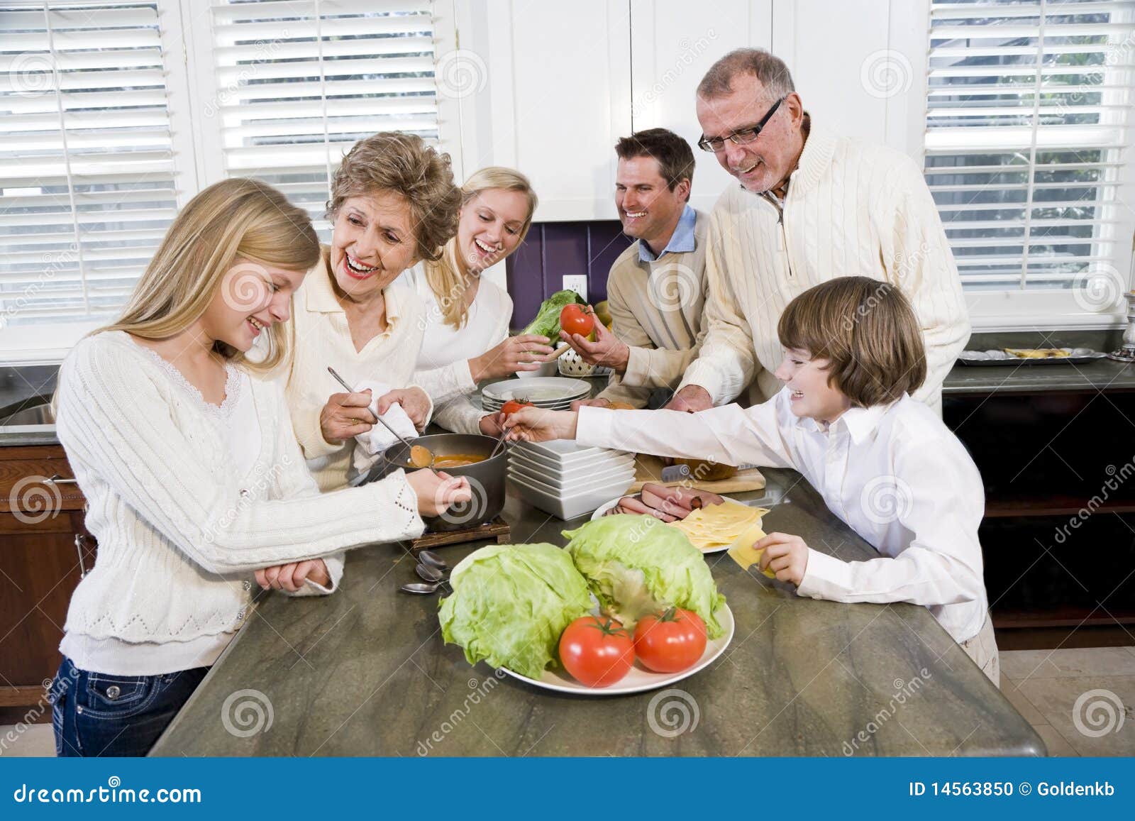 Una famiglia delle tre generazioni in cucina che cucina pranzo ... Cucina pranzo